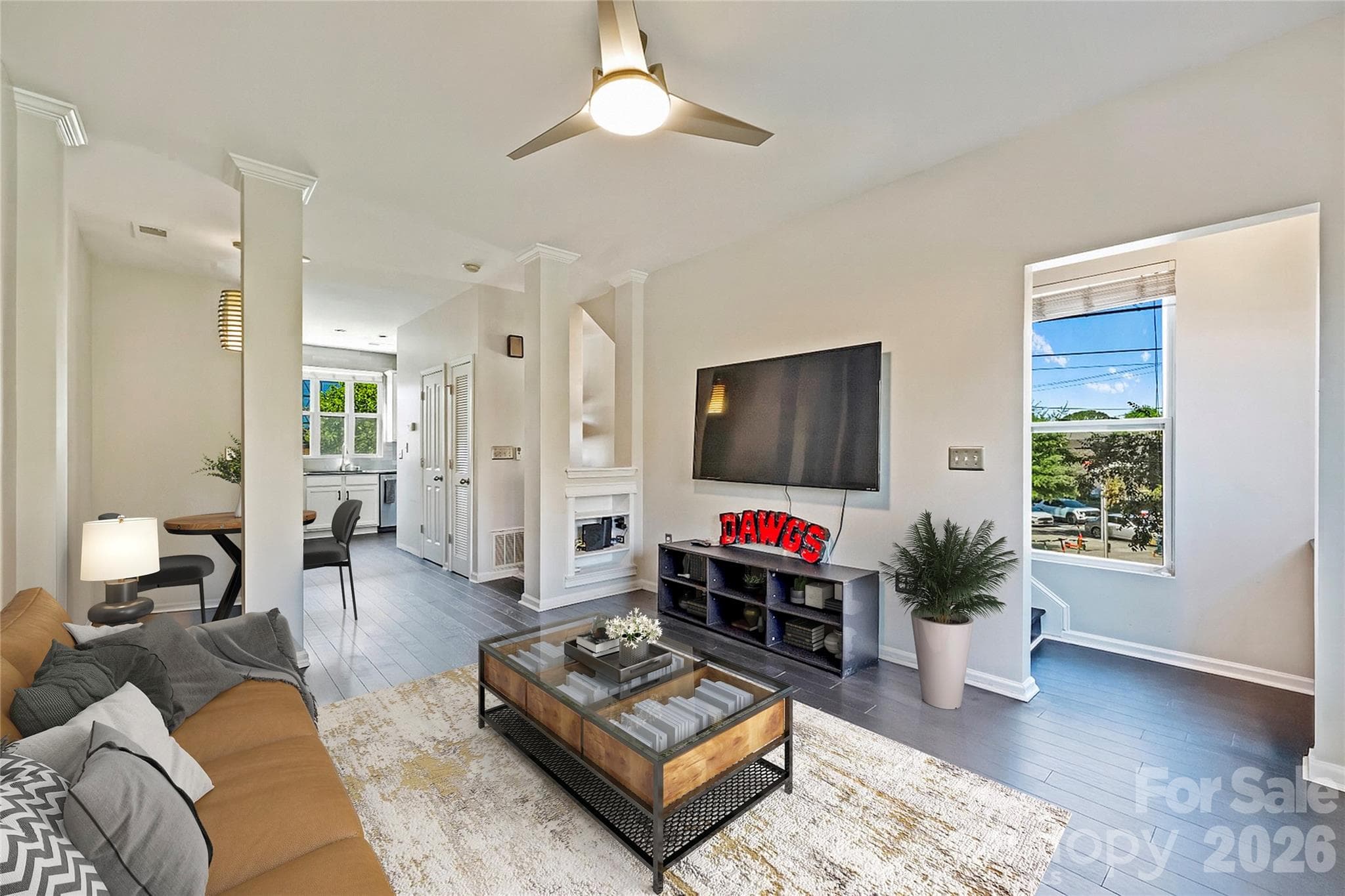 Light-filled living room with new flooring and open-concept design. - Charlotte