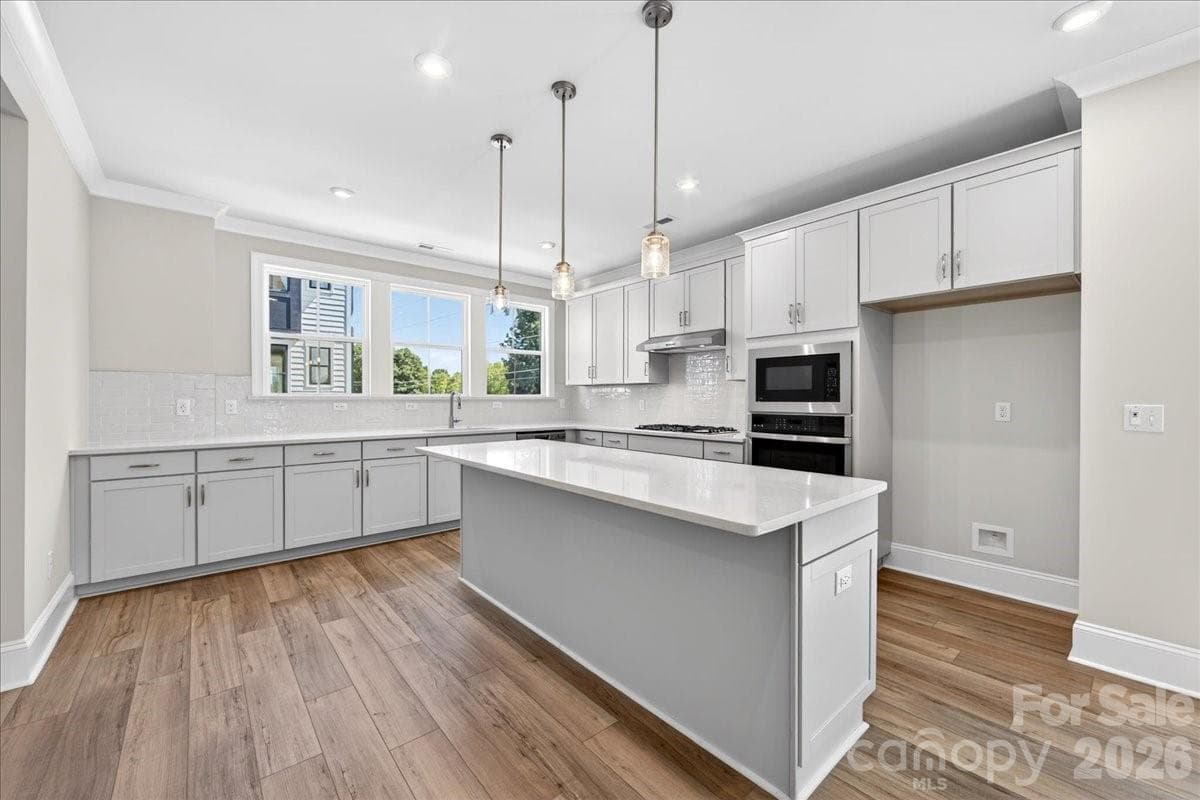 Gourmet kitchen with light gray cabinets and white quartz countertops - 12023 Elsa Lane, Charlotte