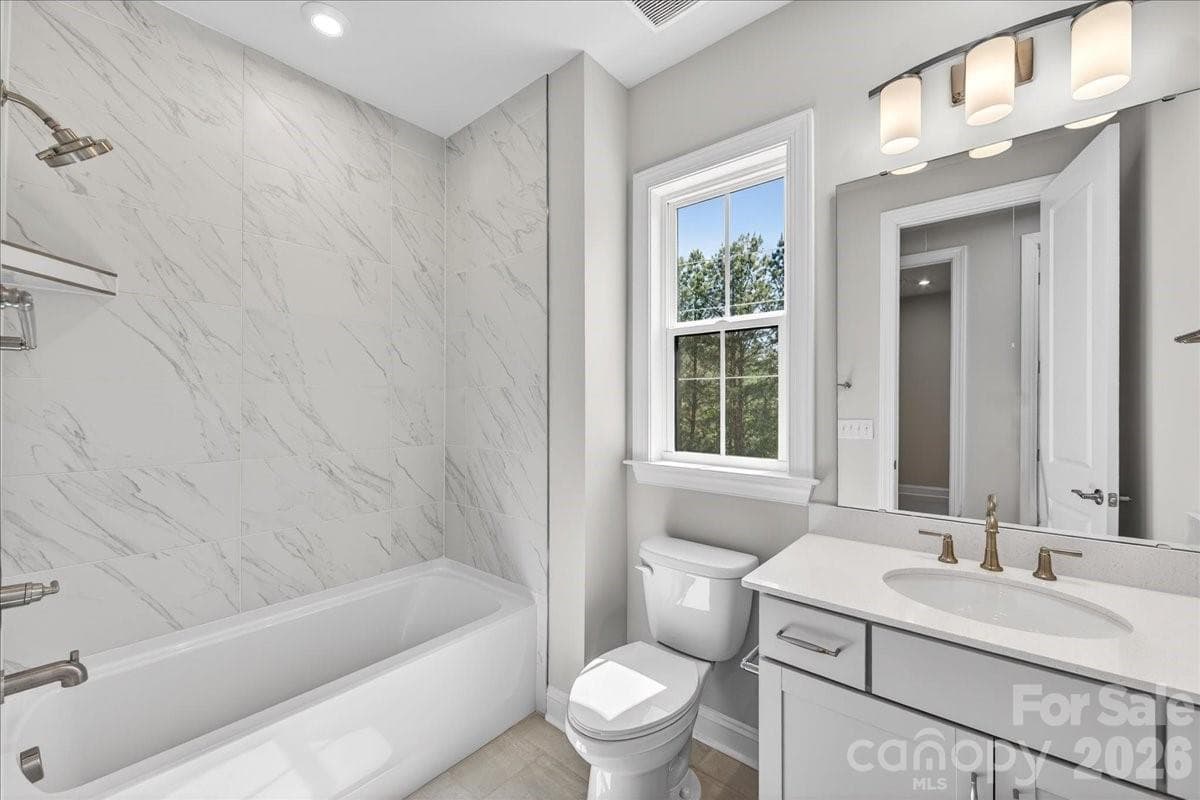 Secondary bathroom with tiled walls above the tub - 12023 Elsa Lane, Charlotte