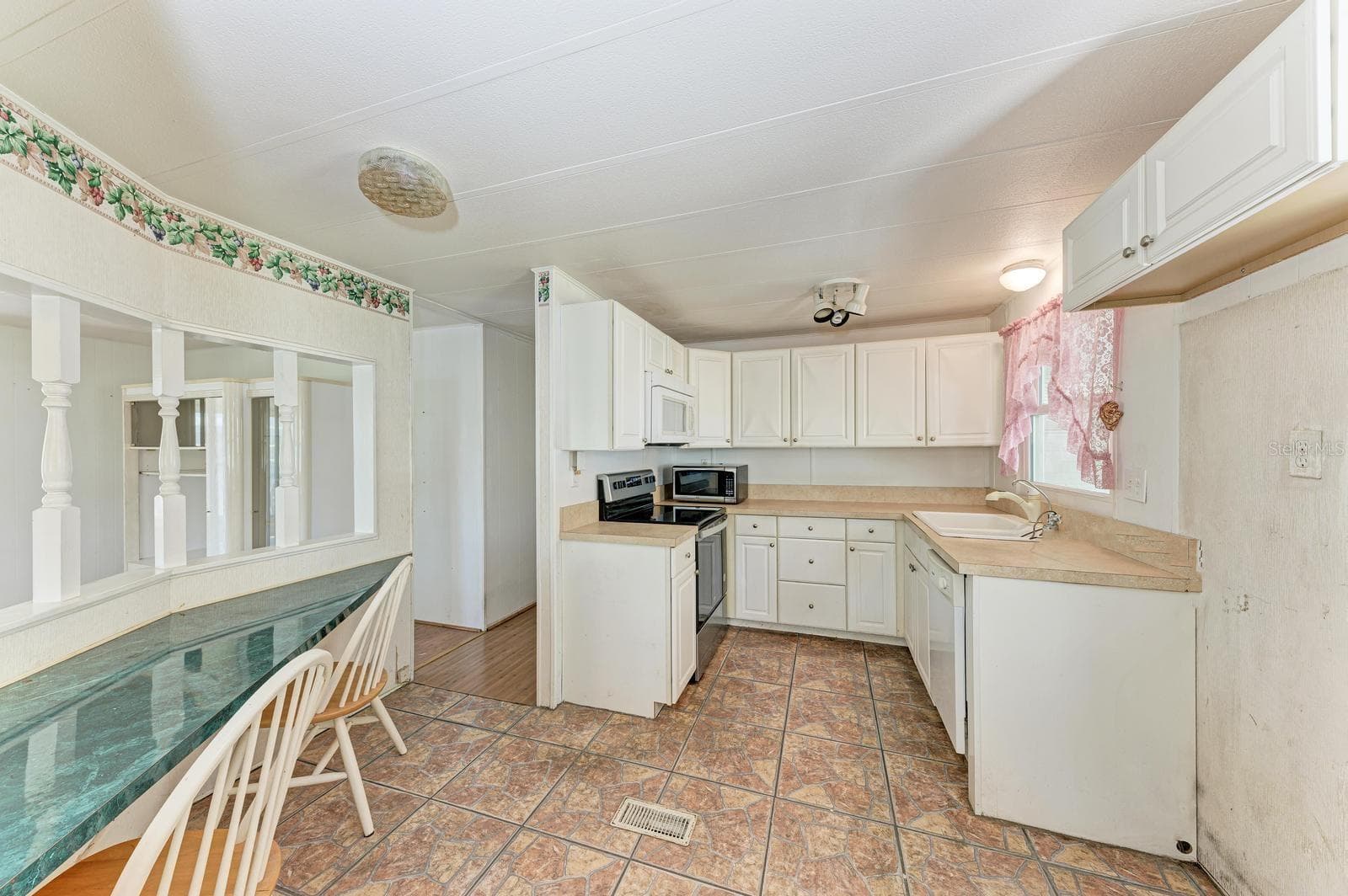 Kitchen with handy writing area on the left - 348 TROPIC DR, OSPREY