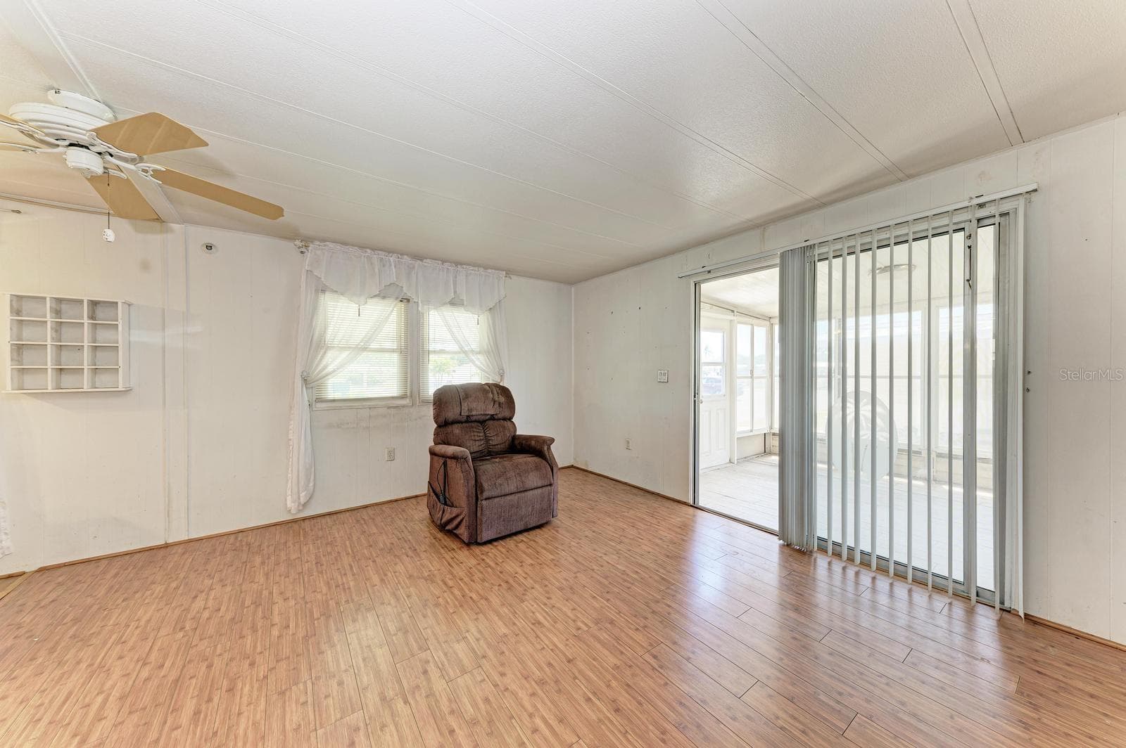 Living room with recliner massage  chair.   It's included. - 348 TROPIC DR, OSPREY