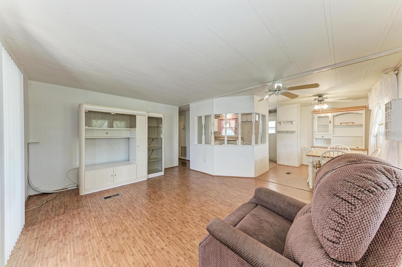 Living room with entertainment center across the room - 348 TROPIC DR, OSPREY