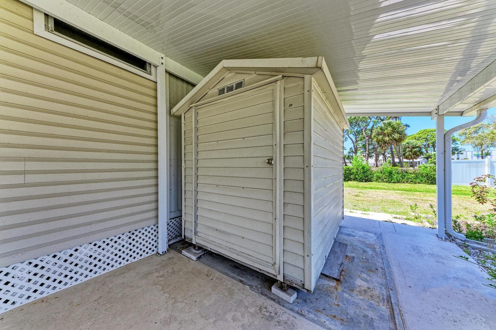 The shed in the carport.  Washer Dryer PLUS  Extra storage - 348 TROPIC DR, OSPREY