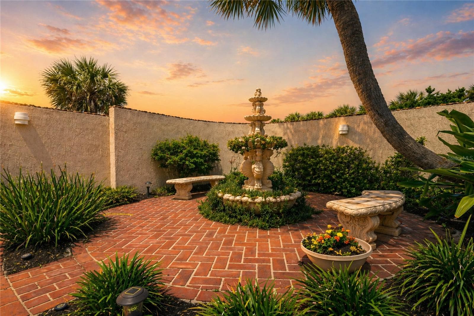 Serene courtyard at golden hour. - 1504 N ATLANTIC AVE, DAYTONA BEACH