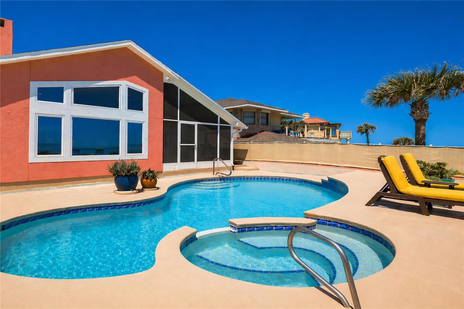 In-ground pool and jacuzzi. - 1504 N ATLANTIC AVE, DAYTONA BEACH