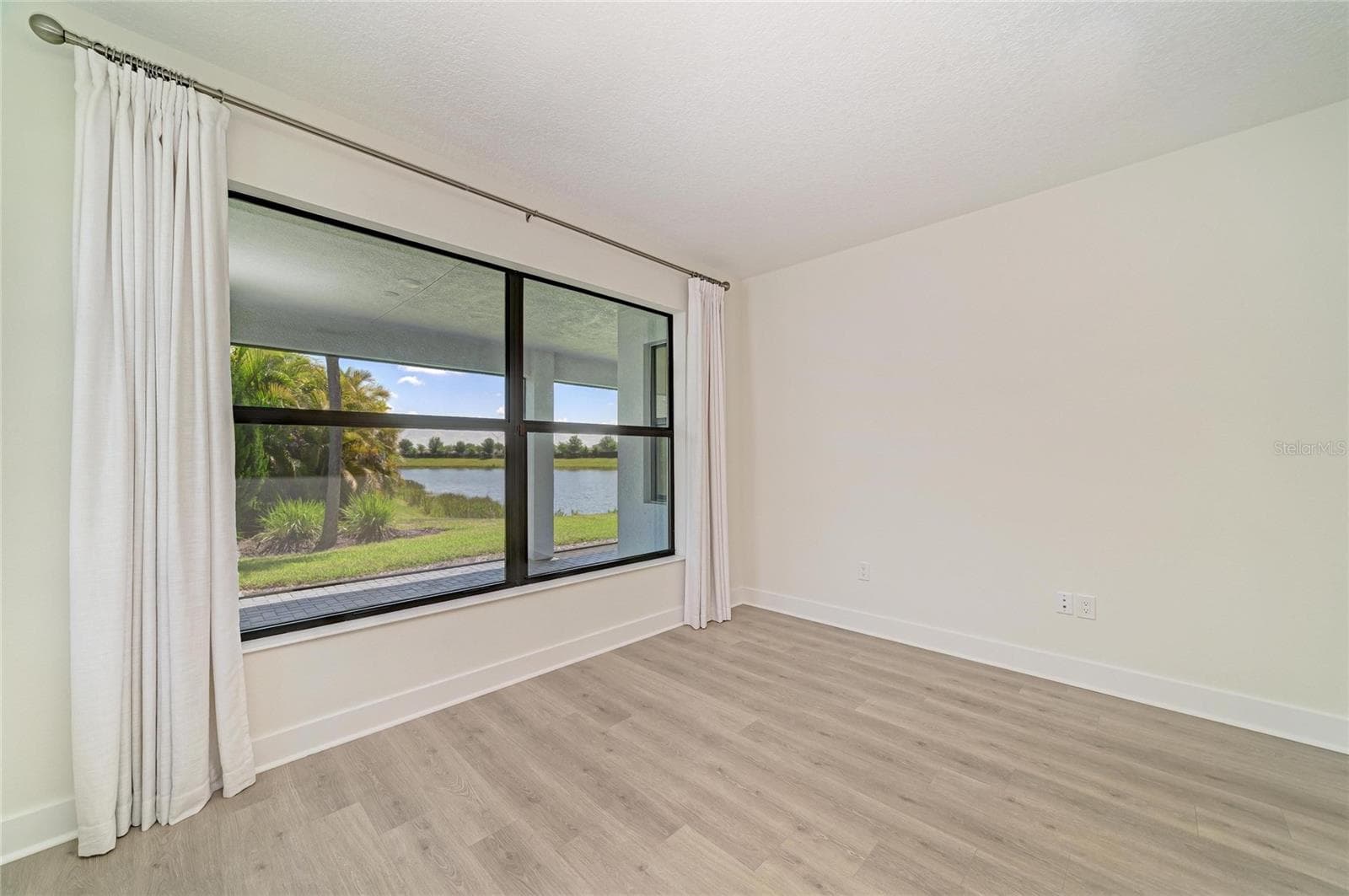 Primary bedroom with view - 5290 BARNETT CIR, BRADENTON