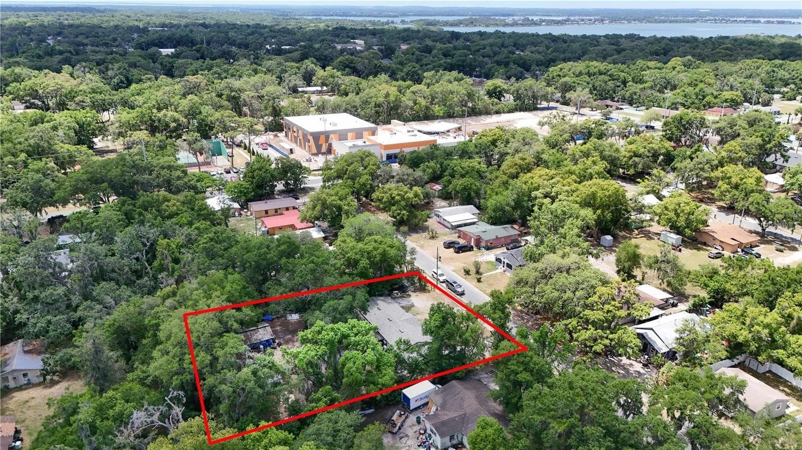 Aerial showing Home in the Neighborhood with Lake Dora in the distance at the top of the frame - 1400 N SIMPSON ST, MOUNT DORA