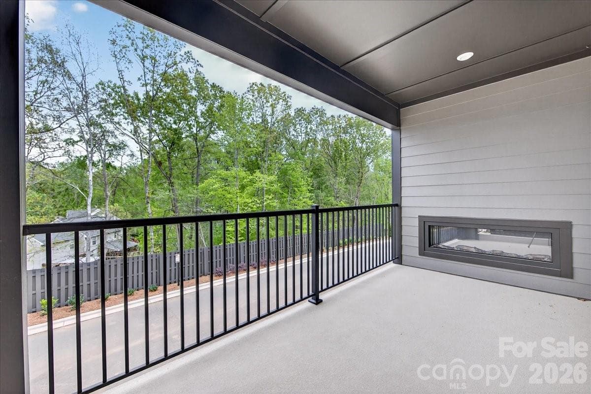 Covered outdoor living space with tree-lined views - 420 Old Town Village Road, Waxhaw