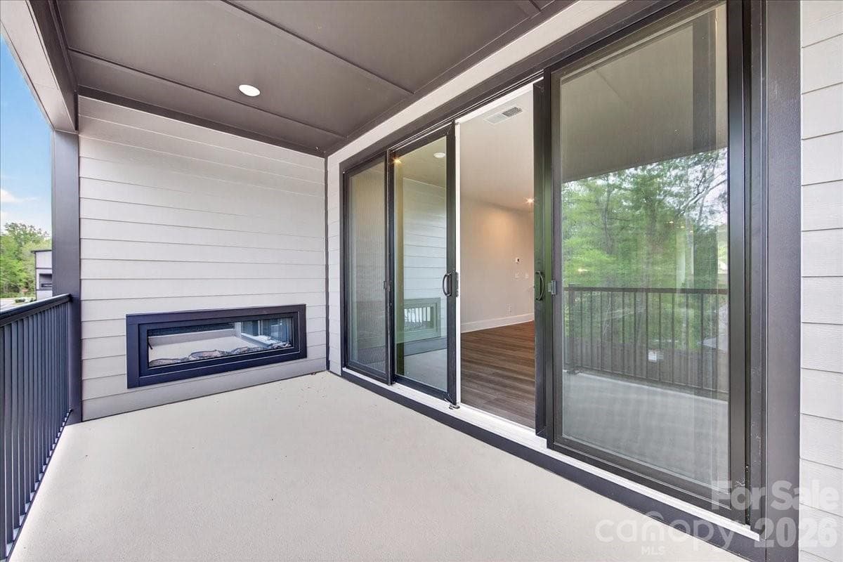 Covered outdoor living space with an electric fireplace - 420 Old Town Village Road, Waxhaw