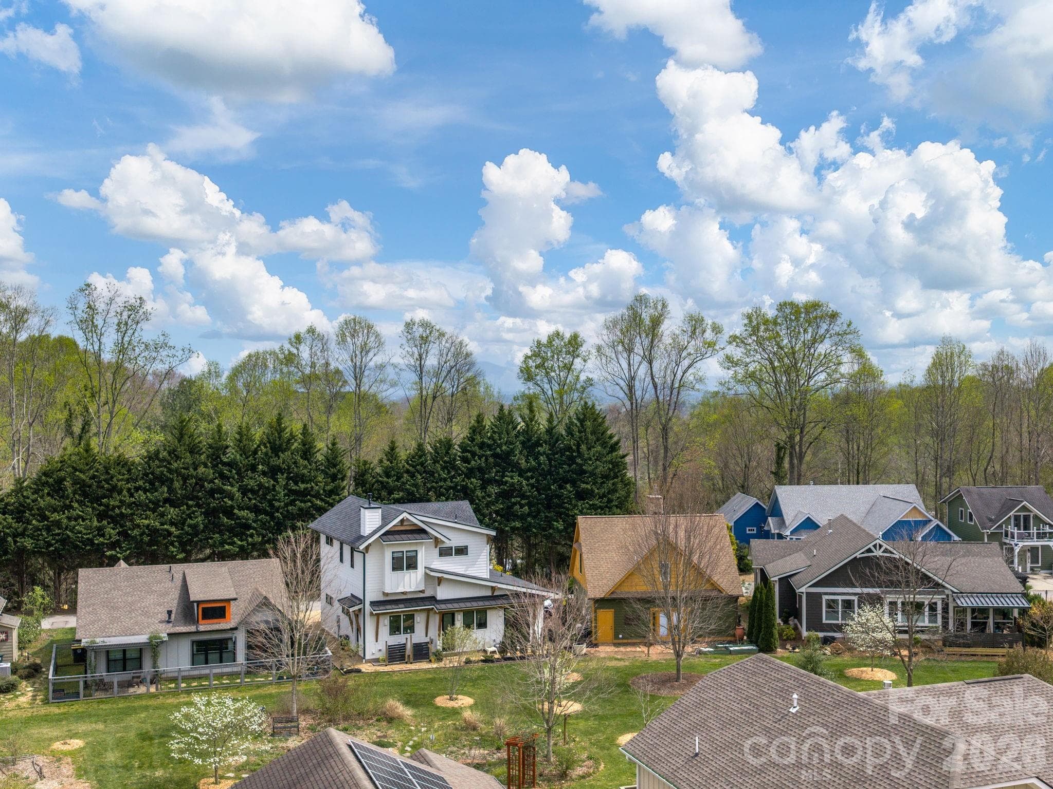 Drone perspective illustrating the potential seasonal mountain view from the future third-level deck at 48 Verde Drive. - Asheville