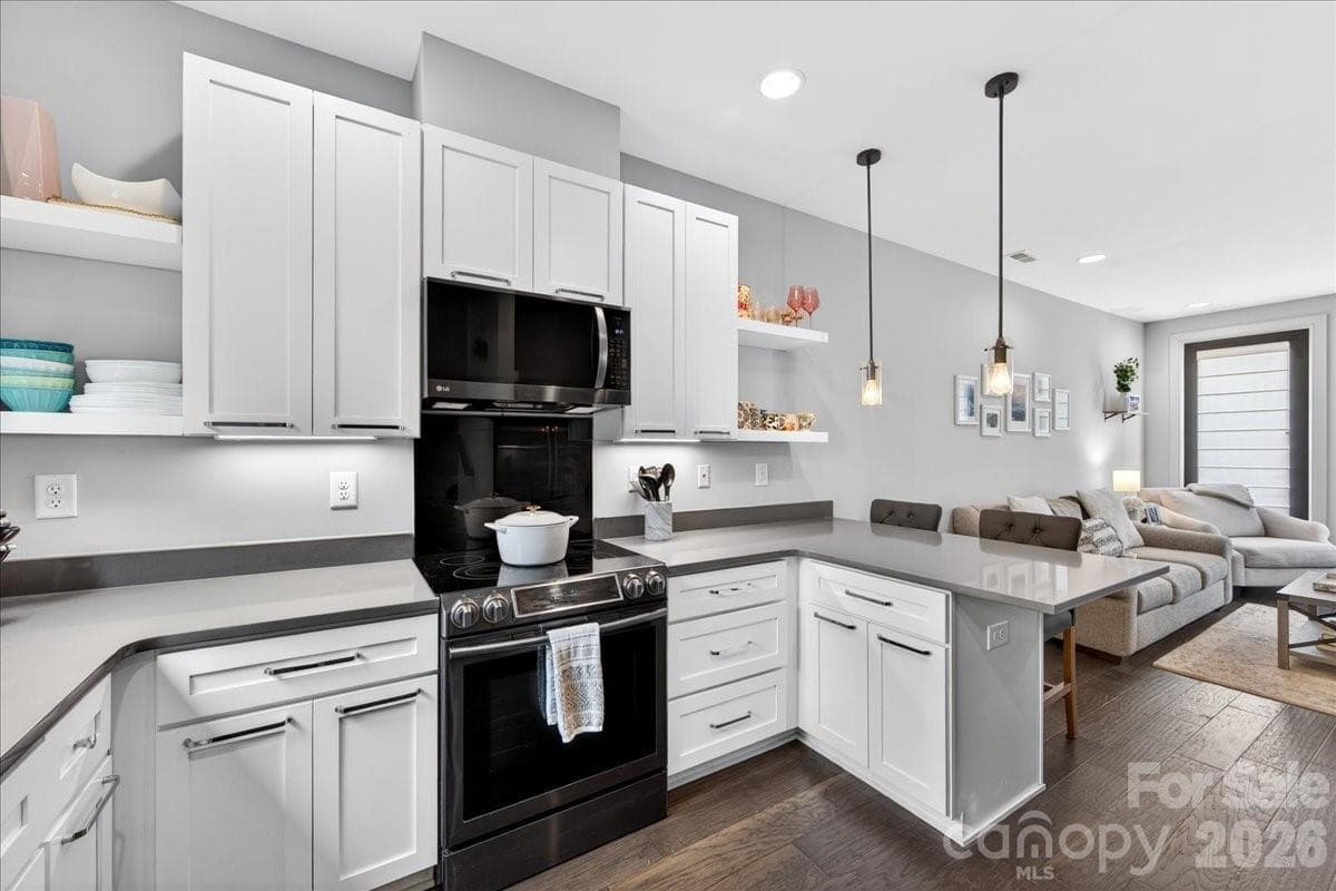 Kitchen with quartz countertops and black stainless appliances - Charlotte