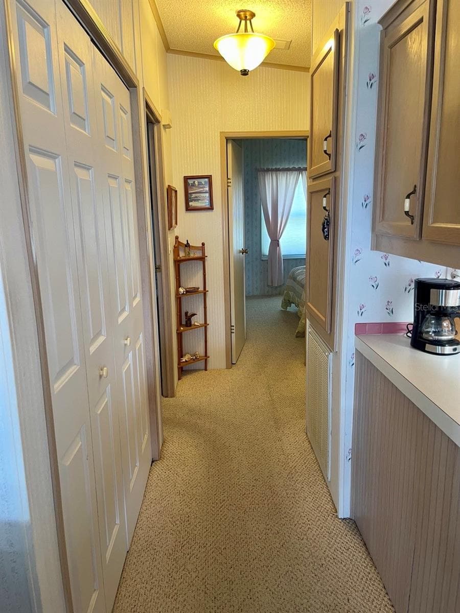 Hallway to bedrooms with indoor laundry closet - 152 SHADY LN #152, PALMETTO
