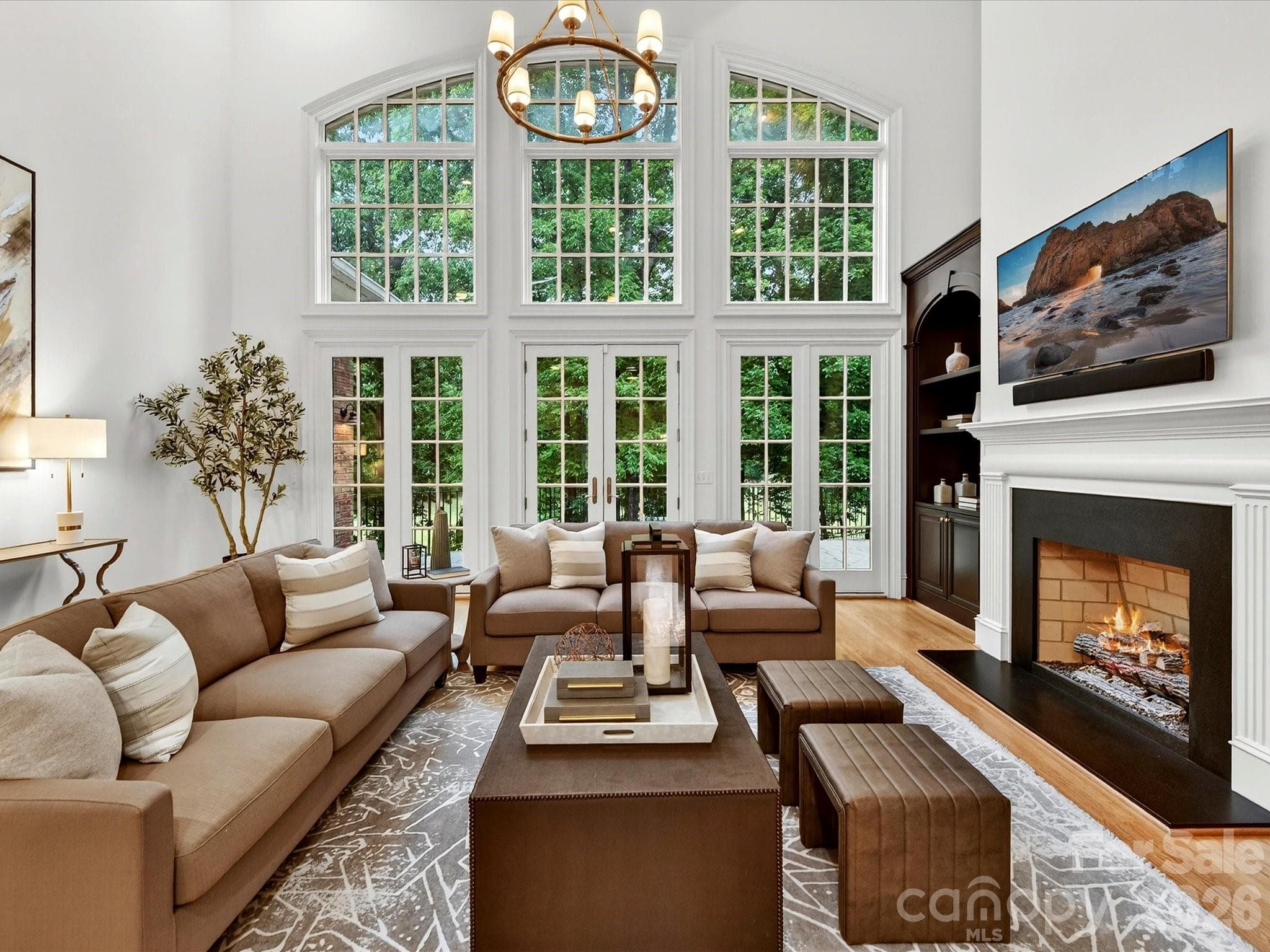 2 story great room with fireplace and french doors leading to upper terrace overlooking the golf course - Charlotte
