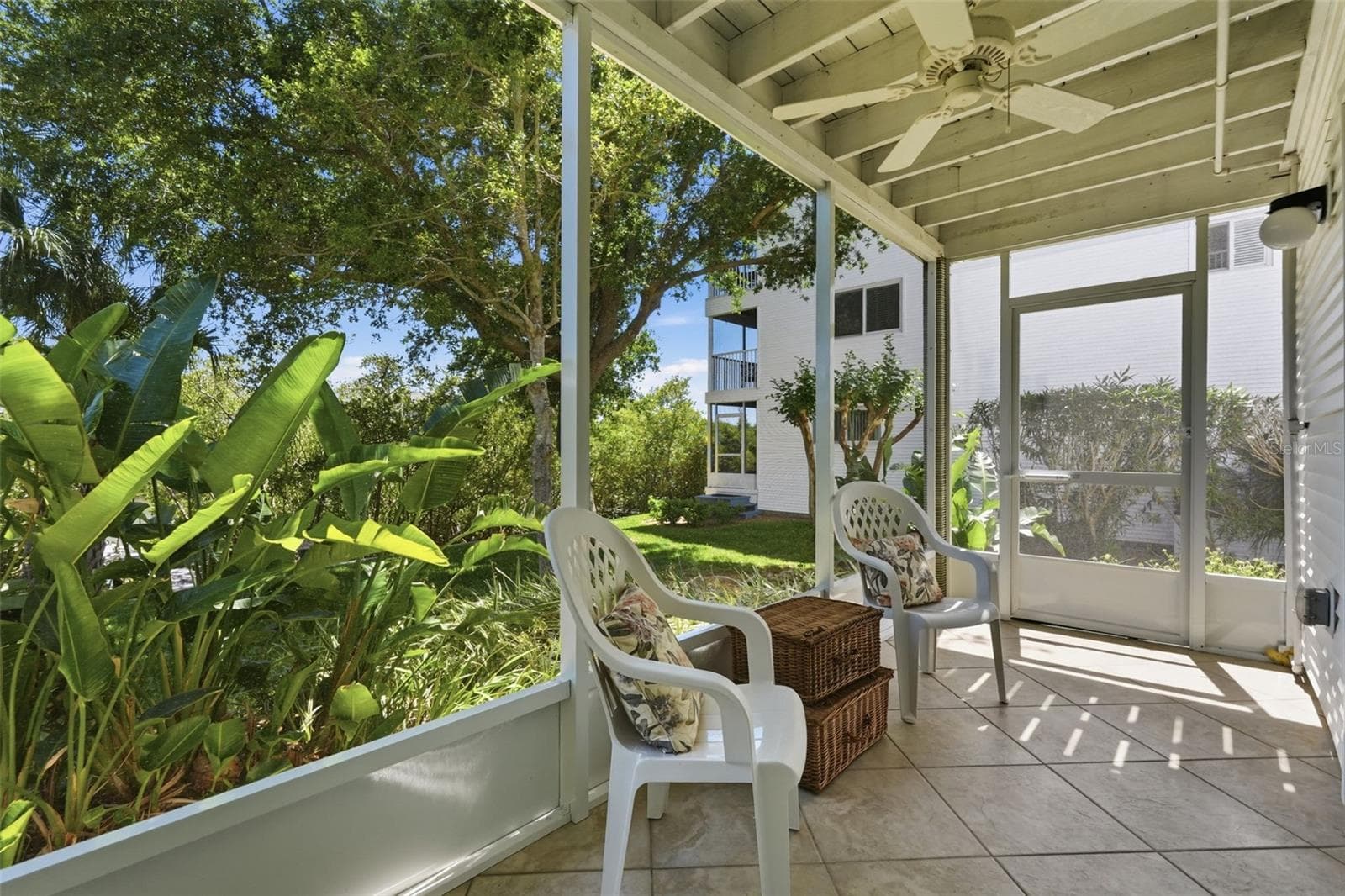 Side door of screened porch opens to concrete patio and green space to the dock. - 14837 SEMINOLE TRL, SEMINOLE