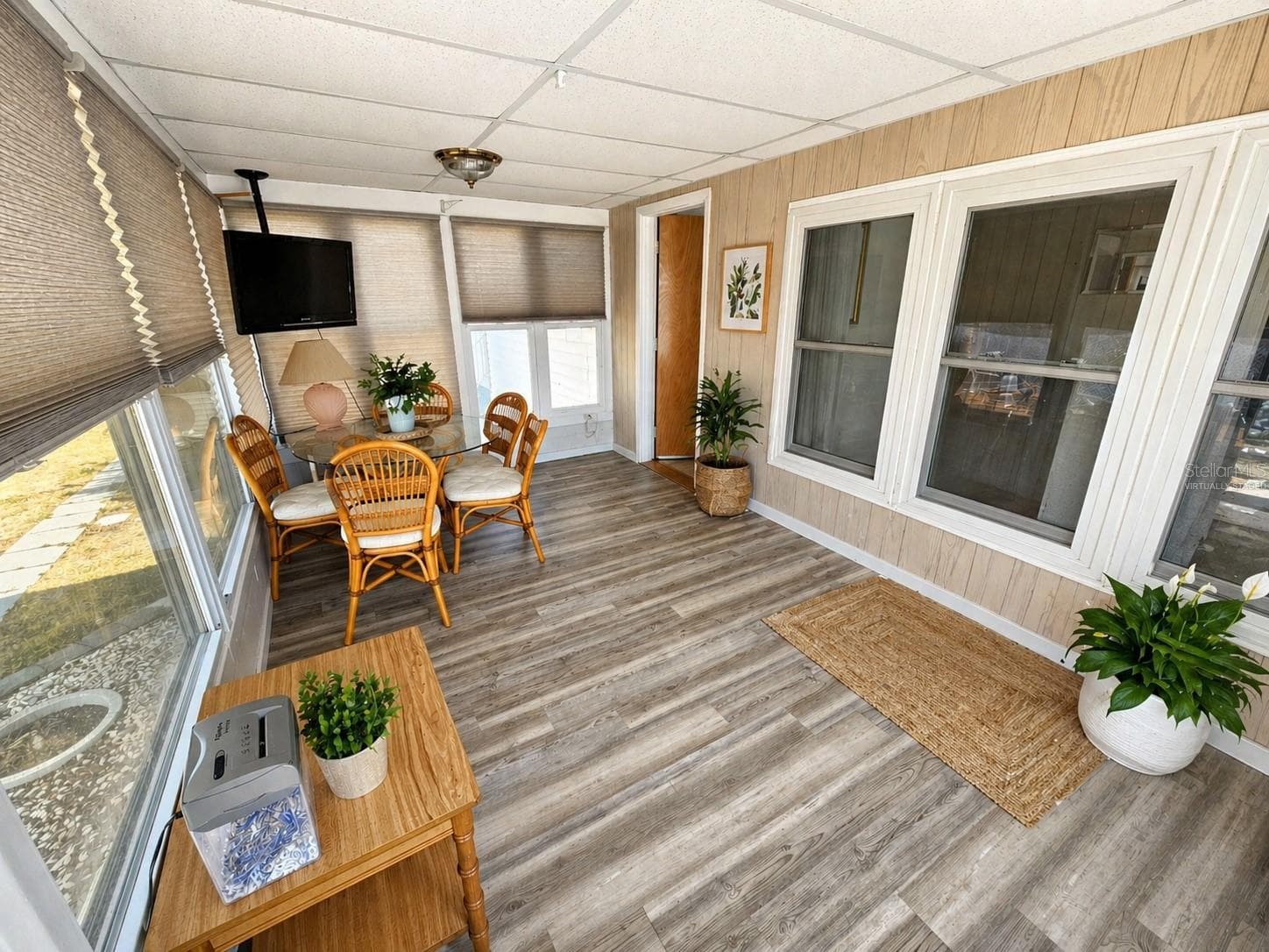 Florida room with a few chairs removed virtually staged - 205 VIA VENETO, VENICE