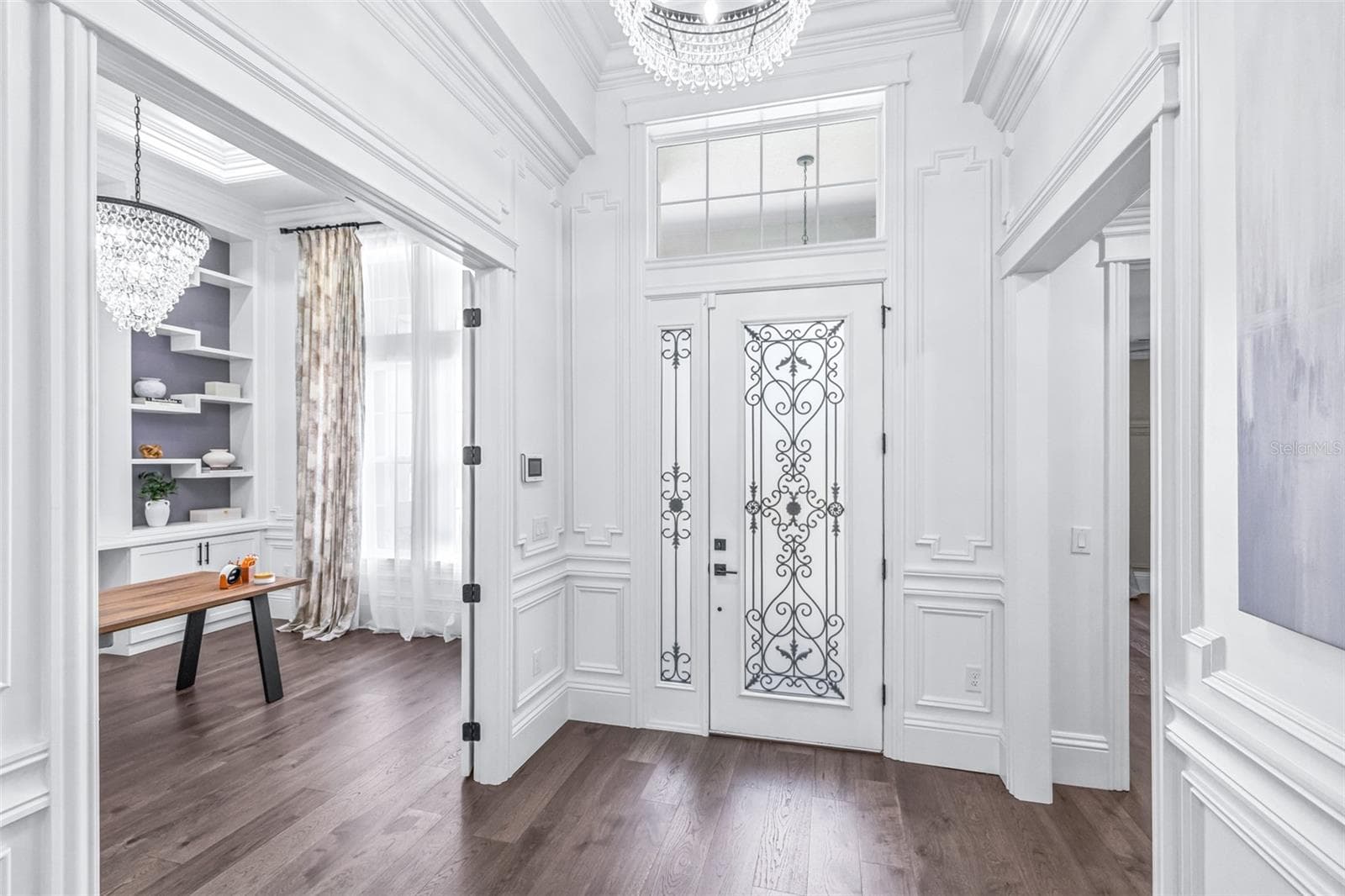 Grand Entryway with Custom Poplar Trim where Chandeliers Adorn Soaring Ceilings - 7190 GRAYBROOK DR, WESLEY CHAPEL