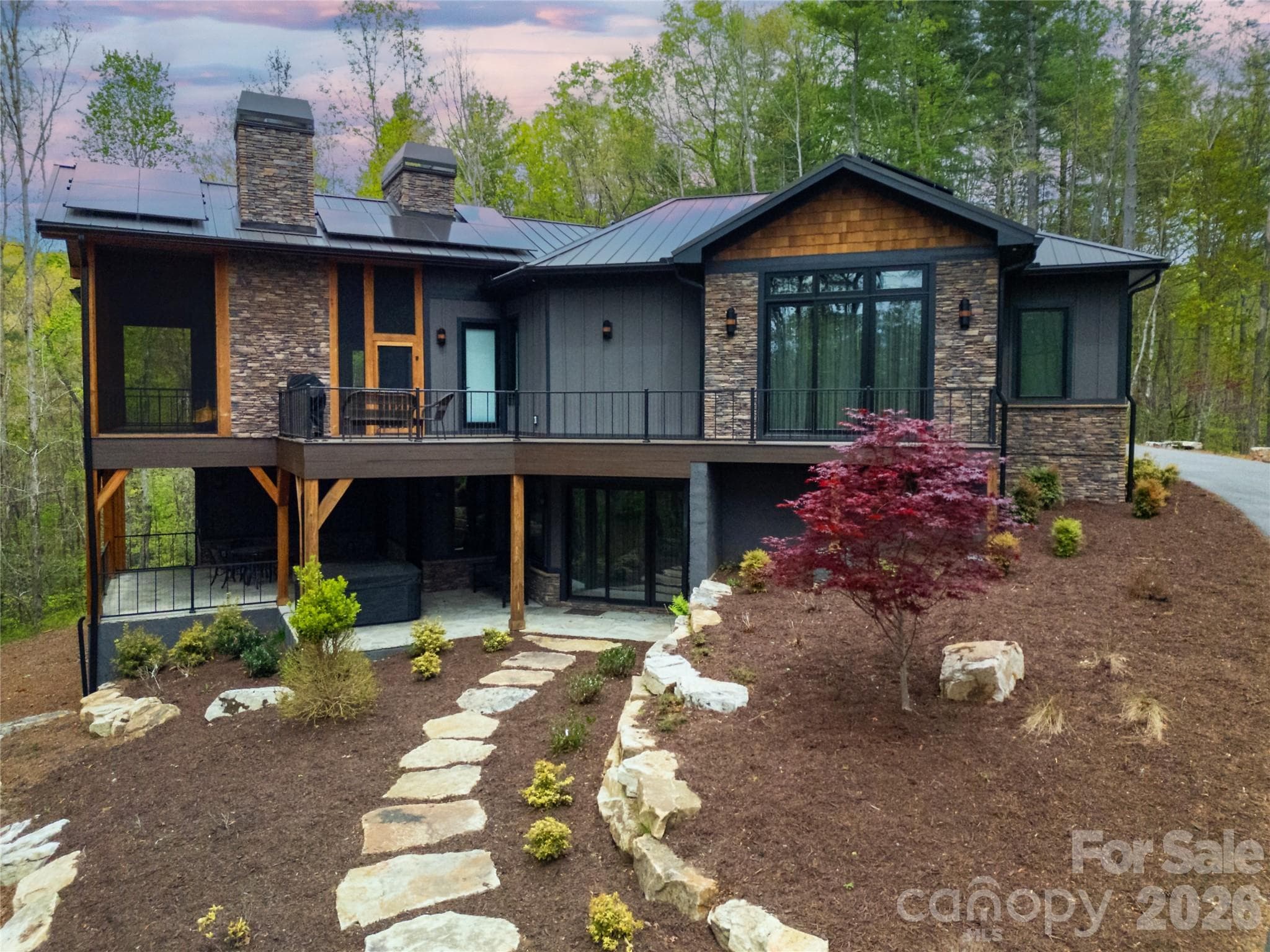 This image captures a side view of the home, specifically highlighting the presence and features of the decks attached to the structure. - Brevard