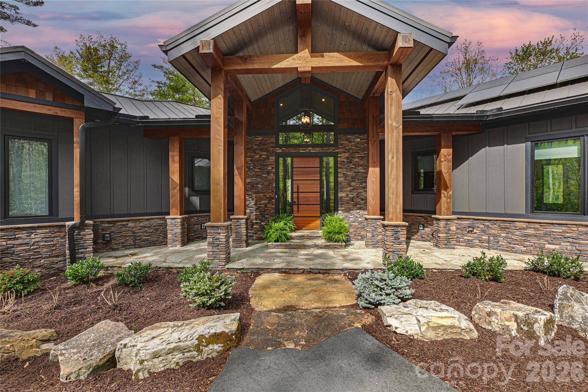 Inviting covered entryway with well-maintained landscaping. - Brevard
