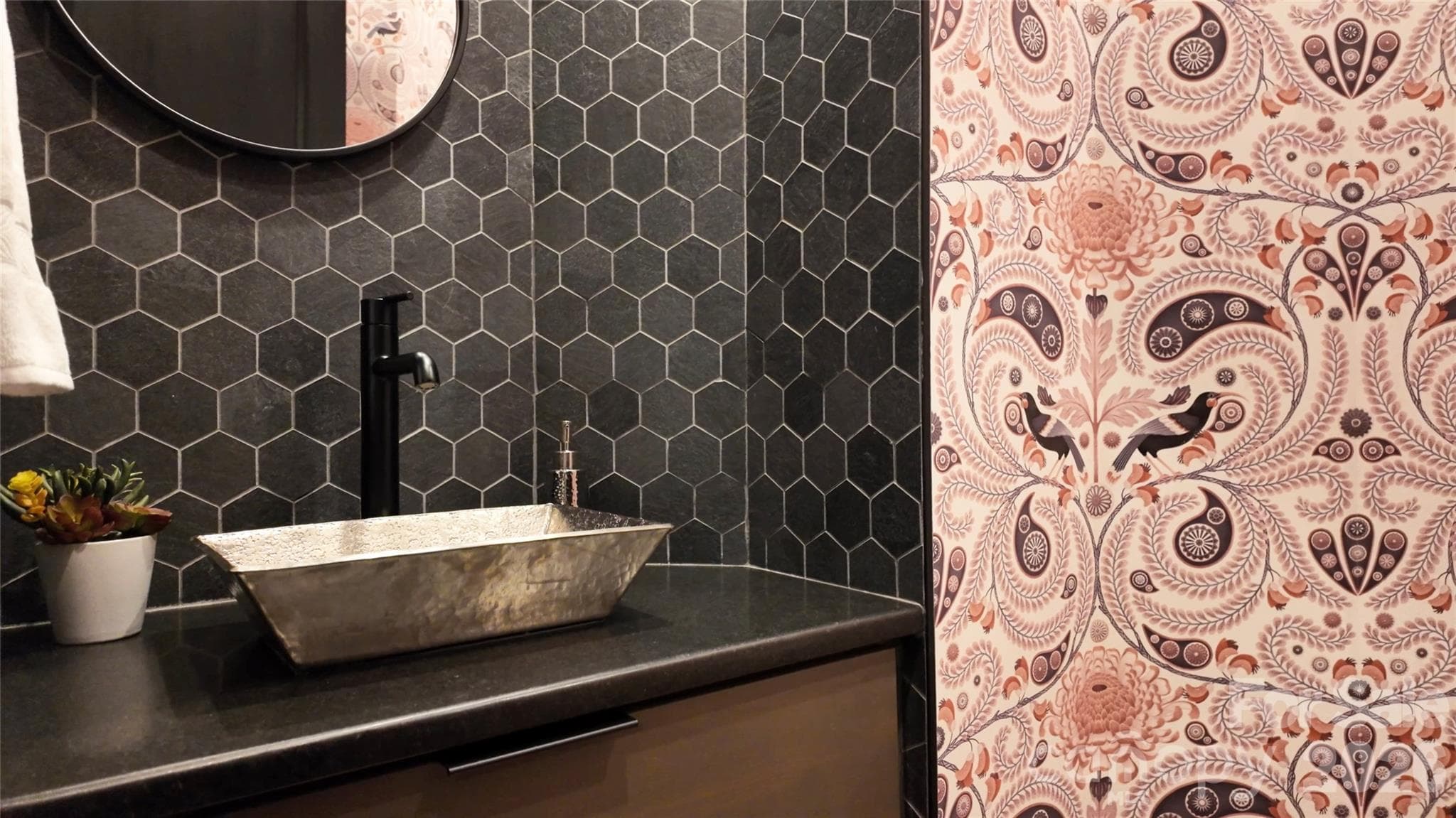 Main level guest half bath features sophistcated finishes, complemented by stylish wallpaper that brings fun, and unexpected flair. - Brevard