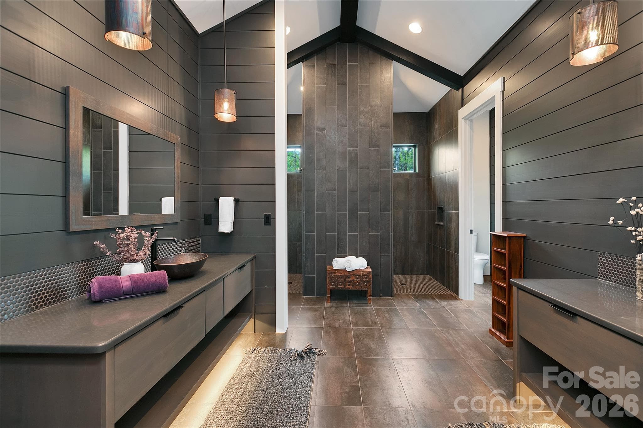 Beautifully appointed , the primary bath showcases dual vanities set on opposite sides offering both elegance and enhanced privacy. - Brevard