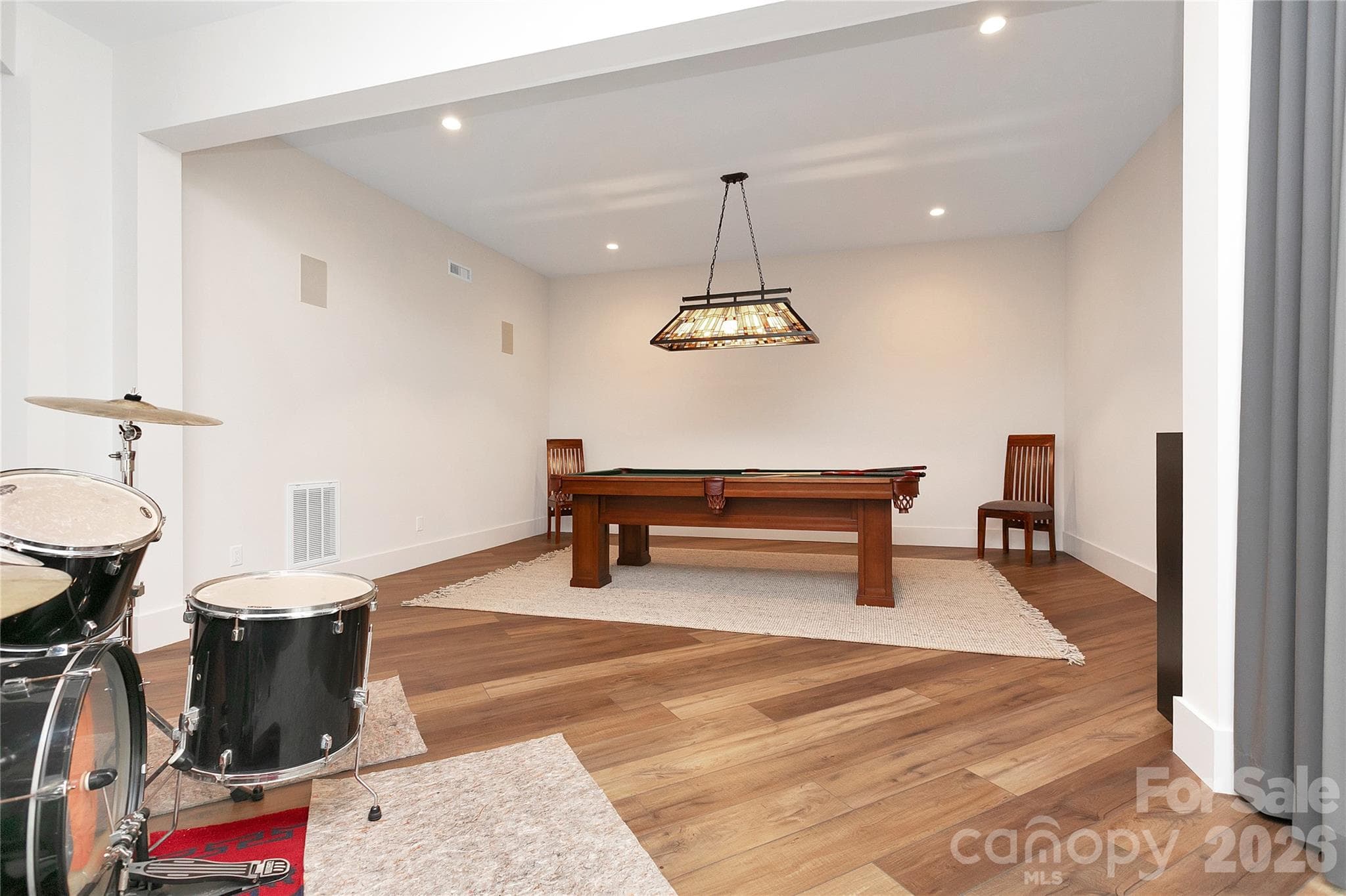 Lower level includes a dedicated game room with a pool table, providing a comfortable and casual space for recreation and downtime. - Brevard
