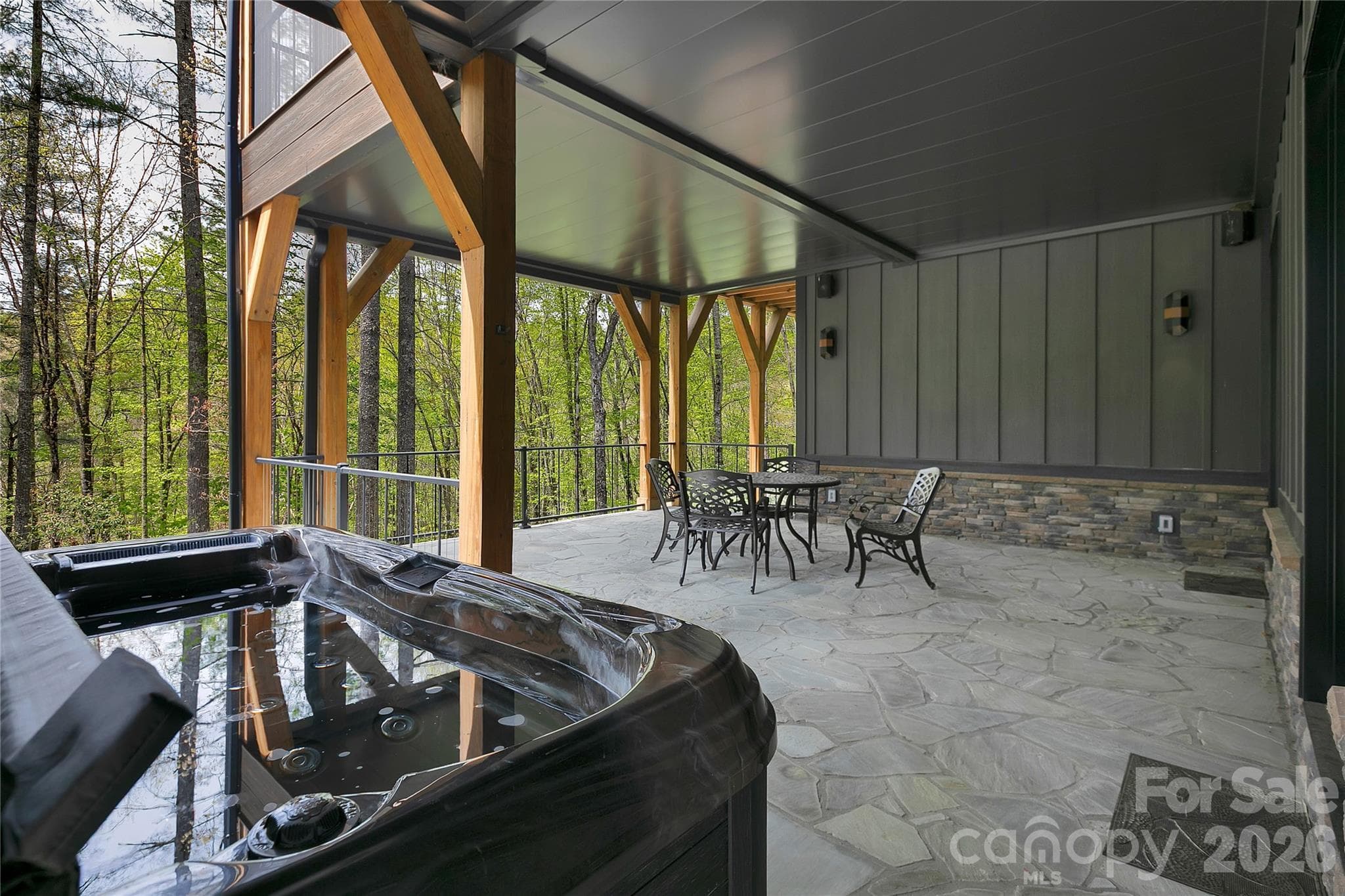 The lower level hot tub and patio space is perfect for unwinding after a day of hiking, pickleball, or any of the many outdoor adventures the area offers. - Brevard