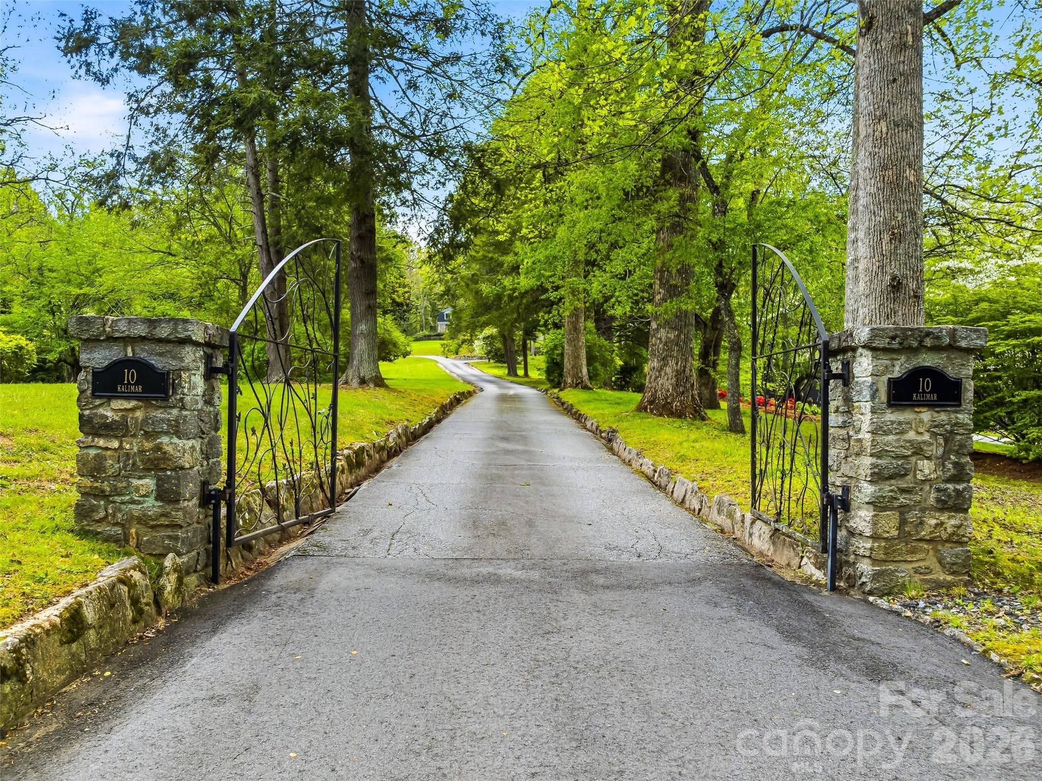 Gated entrance and tree-lined drive create a private and welcoming approach to the property. - 10 Kalimar Heights, Hendersonville