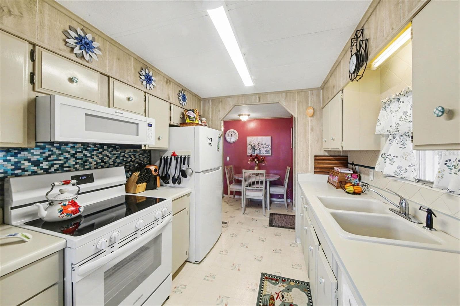 Galley kitchen with natural light coming in from the window. - 732 DOVE AVE, PORT ORANGE