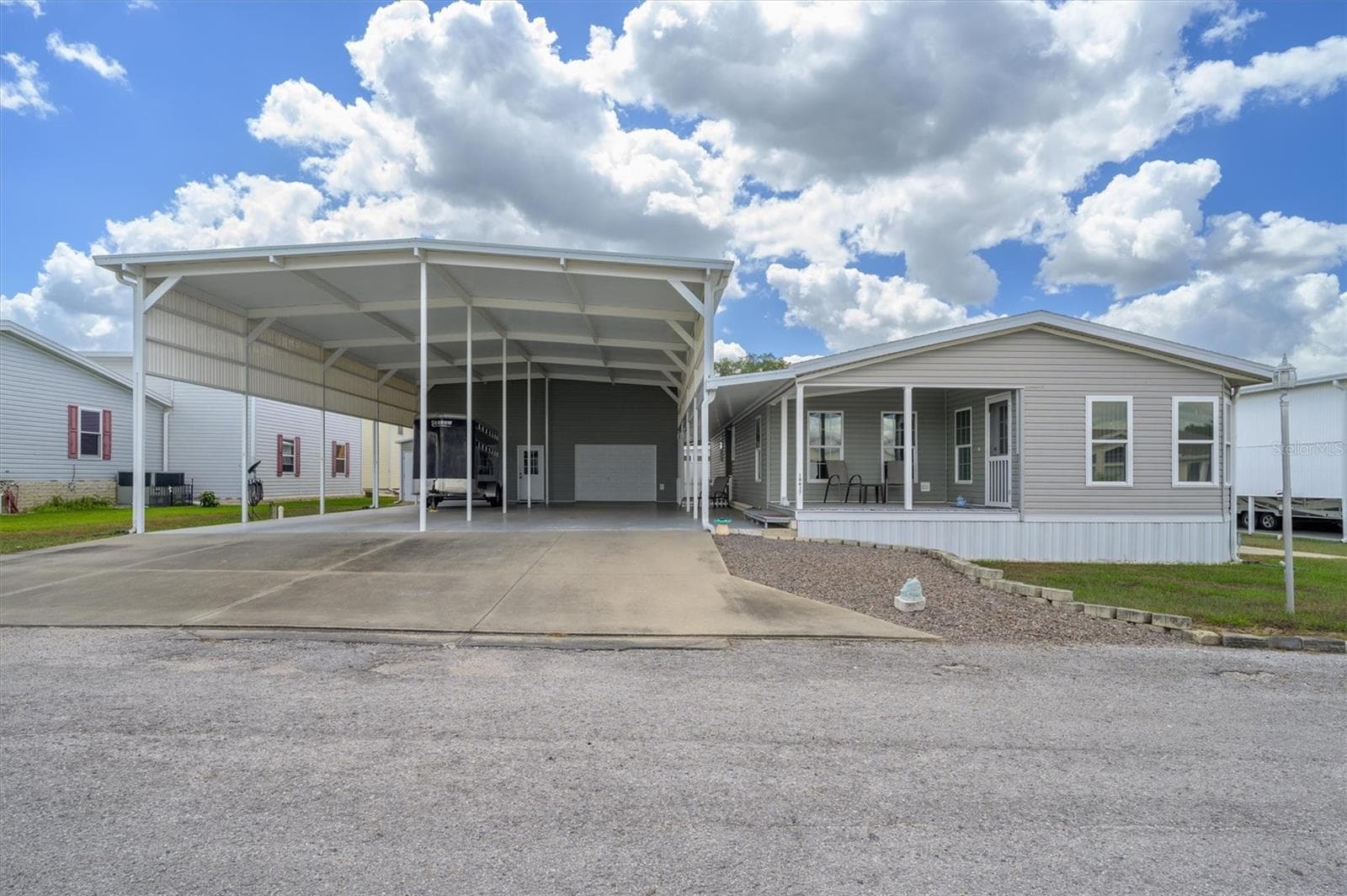 Amazing home with wonderful RV Port which could accommodate large RVs, golf carts, and vehicles. This also includes the workshop, and the garage/workout/flex shop as well.  So much room.  This home is one to come see . - 10027 EQUITY AVE, DADE CITY