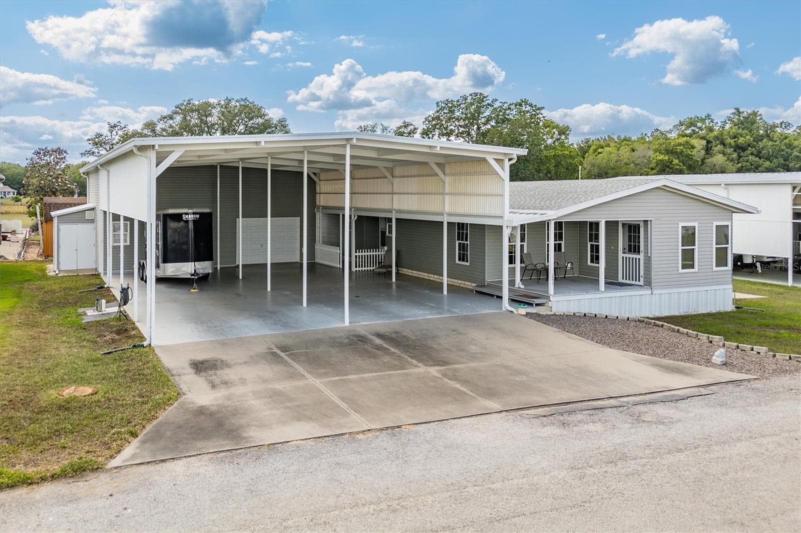This photo shows tool storage room on left side for lawnmower and tools. - 10027 EQUITY AVE, DADE CITY