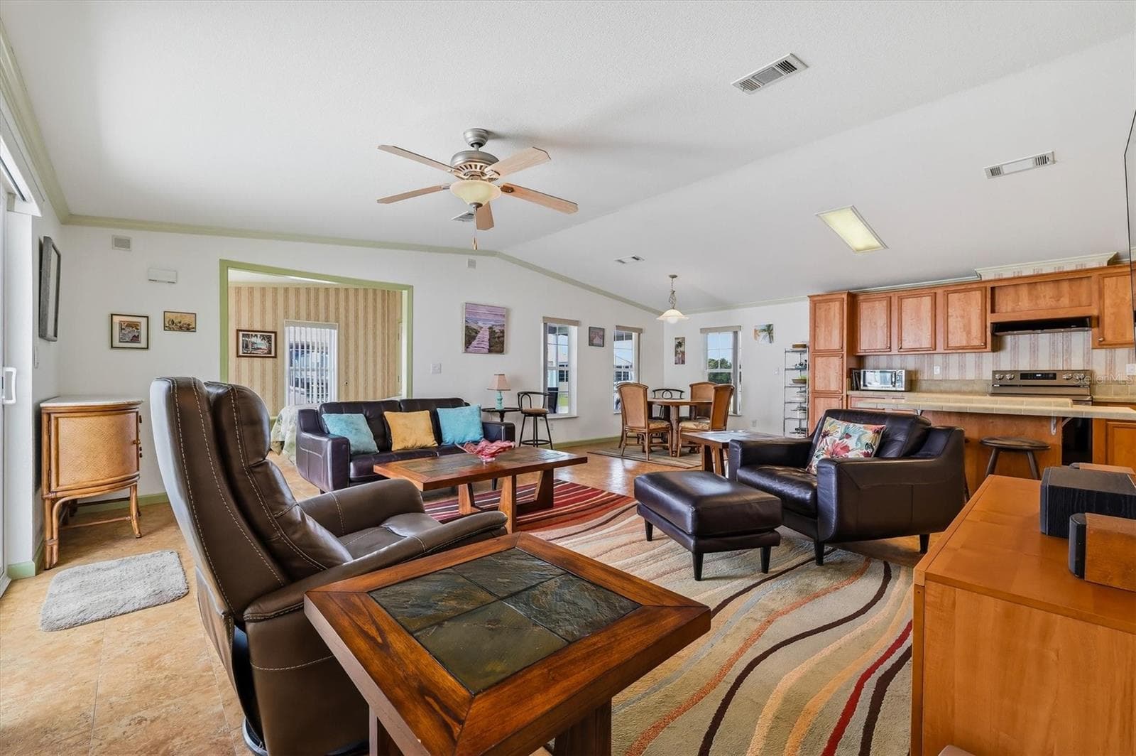 Now to the home!  Beautiful open floorplan - Living room, dining area and kitchen. - 10027 EQUITY AVE, DADE CITY