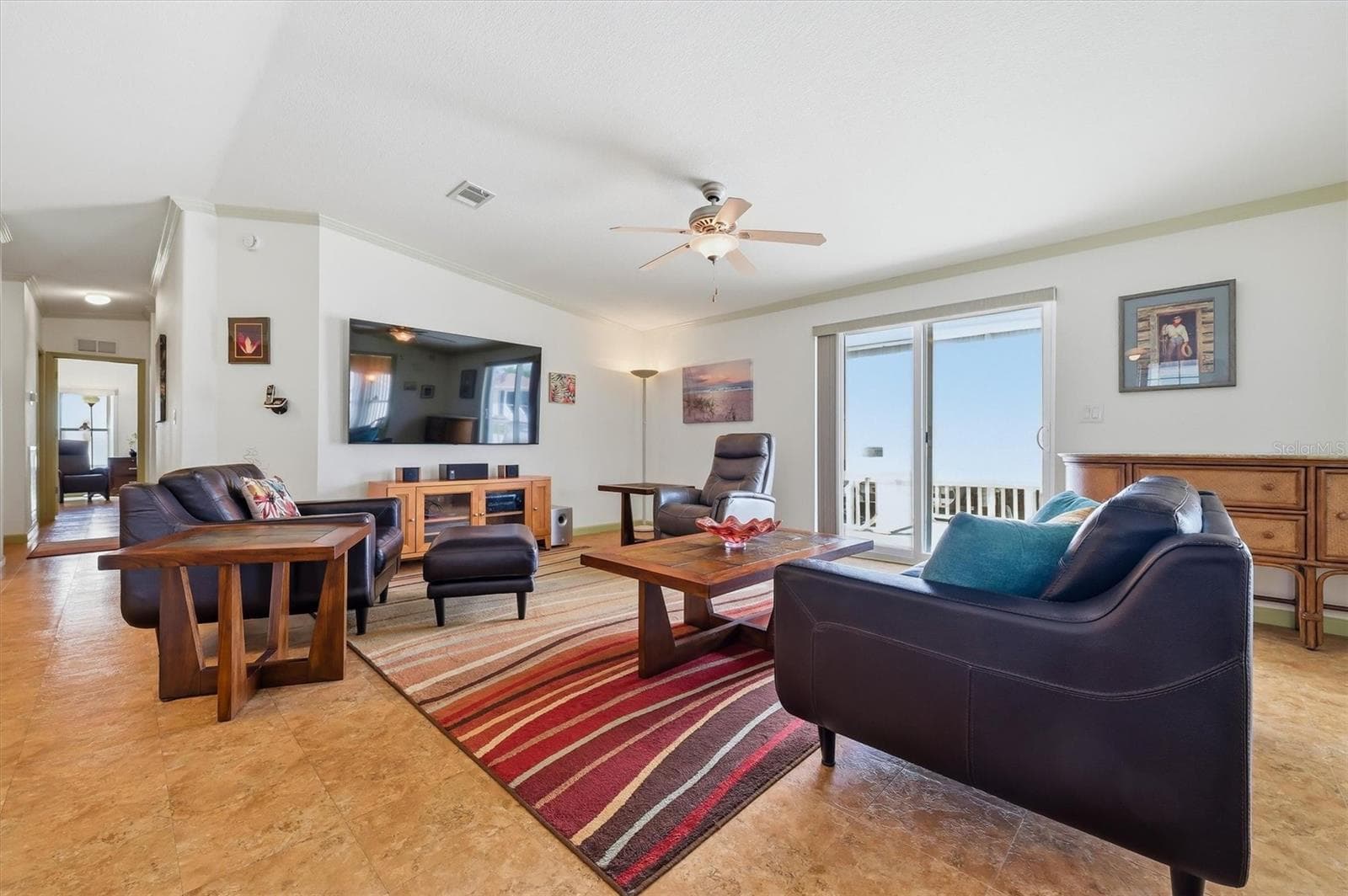 Living Room with sliding doors leading out to the side deck and yard.  Wall tv and stereo system can remain. - 10027 EQUITY AVE, DADE CITY
