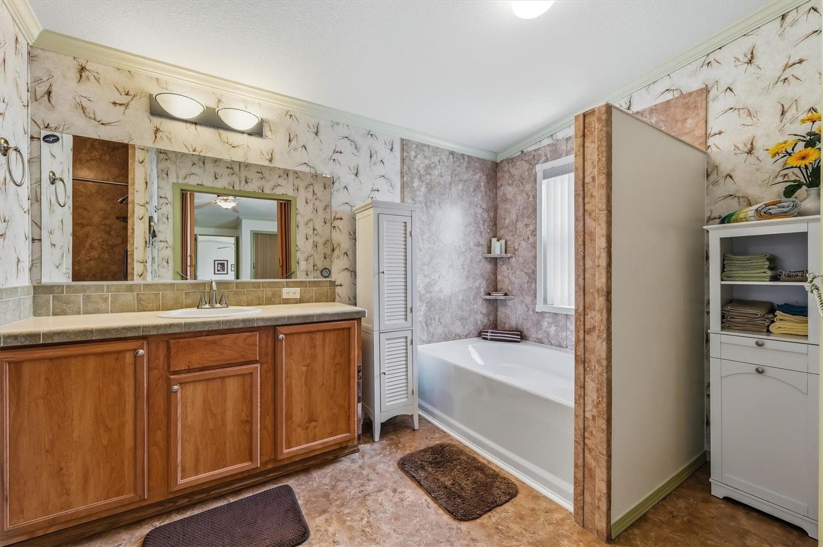 Main bathroom with separate tub and separate shower - 10027 EQUITY AVE, DADE CITY