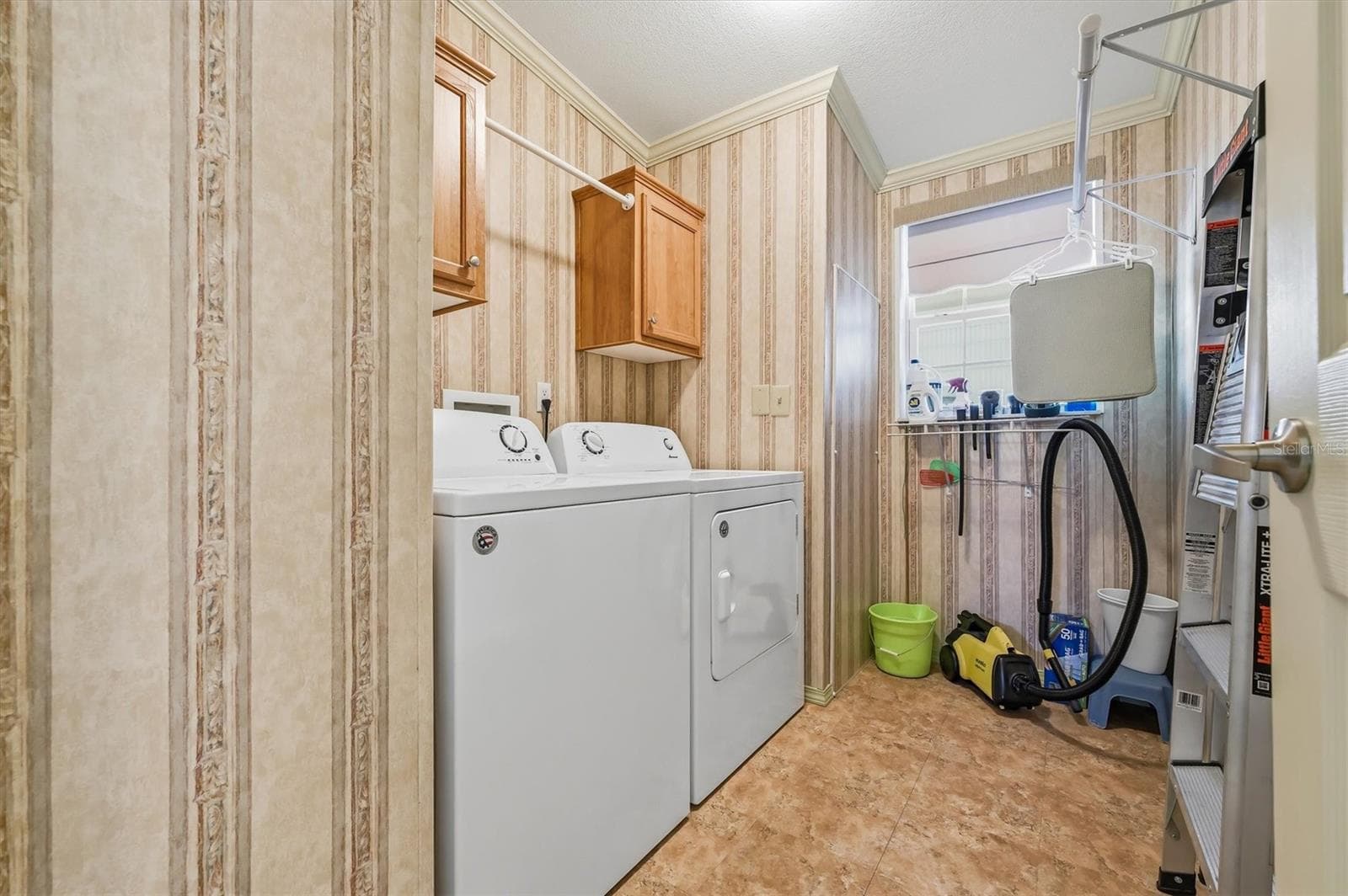 Laundry room in hallway.  Washer and dryer can remain. - 10027 EQUITY AVE, DADE CITY