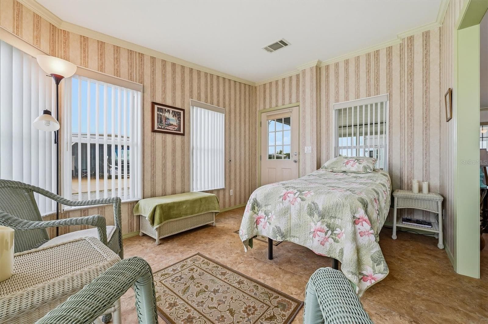 Front flex room showing lots of windows and light,  with door entry from carport. - 10027 EQUITY AVE, DADE CITY