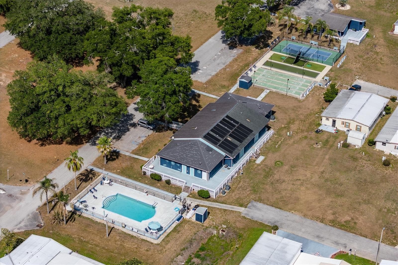 Great amenities with a pool, large clubhouse with games, tables and seating, kitchen,  and bacci ball, shuffleboard and pickleball courts. - 10027 EQUITY AVE, DADE CITY