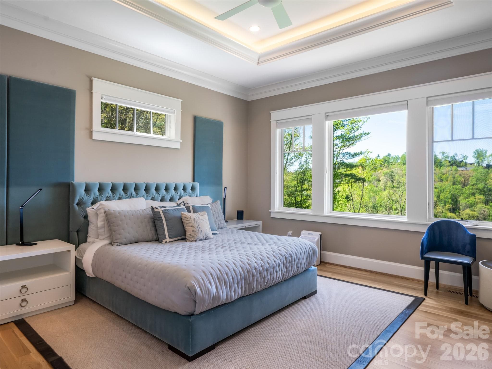 Primary bedroom on main floor with wall of windows overlooking the Blue Ridge Mountains. - 32 Timberwolf Court, Asheville