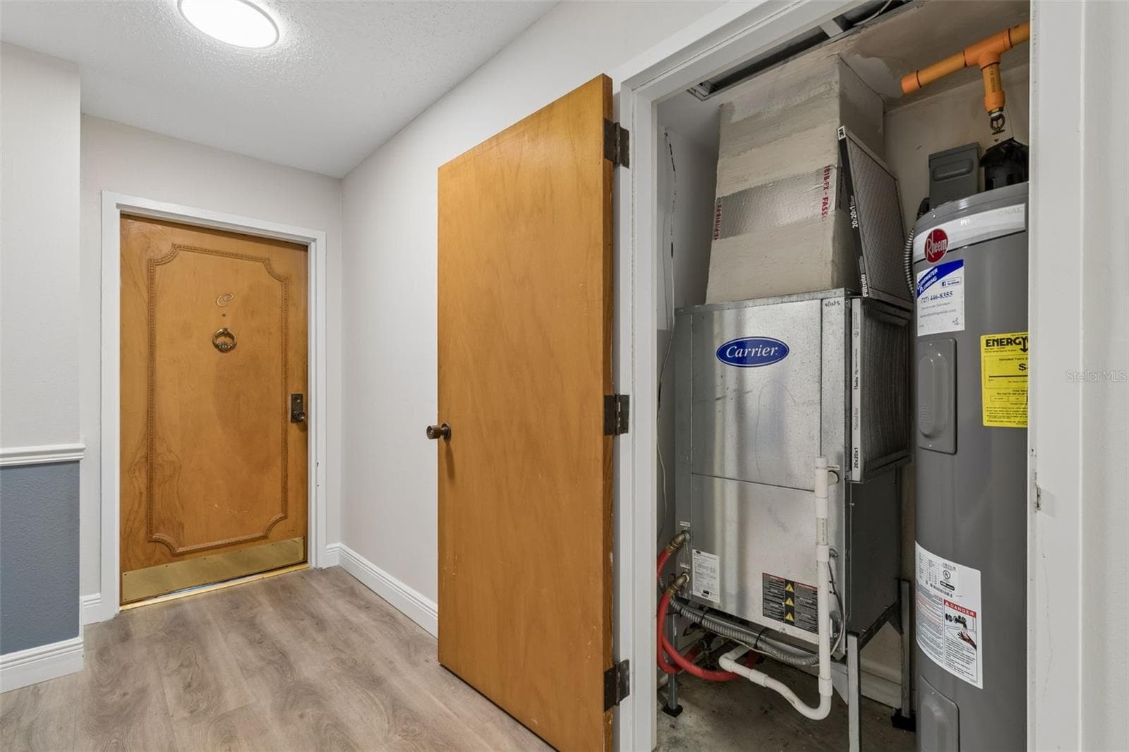 Utility closet for HVAC and water heater outside unit door - 80 ROGERS ST #6C, CLEARWATER
