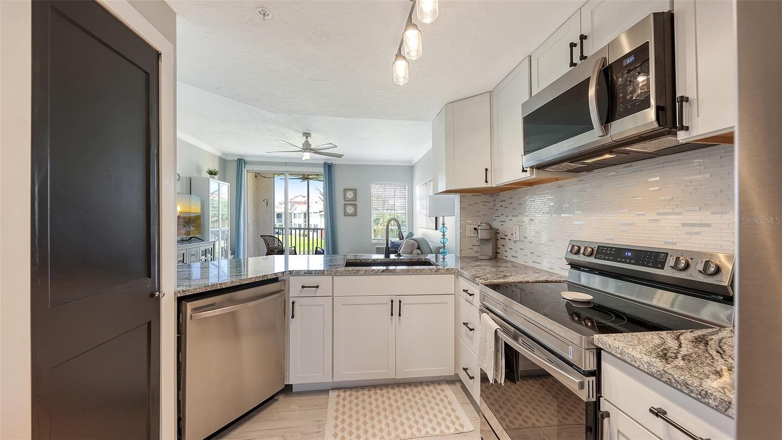 Solid wood cabinets, stainless appliances and granite countertops. - 5655 BENTGRASS DR #9-116, SARASOTA