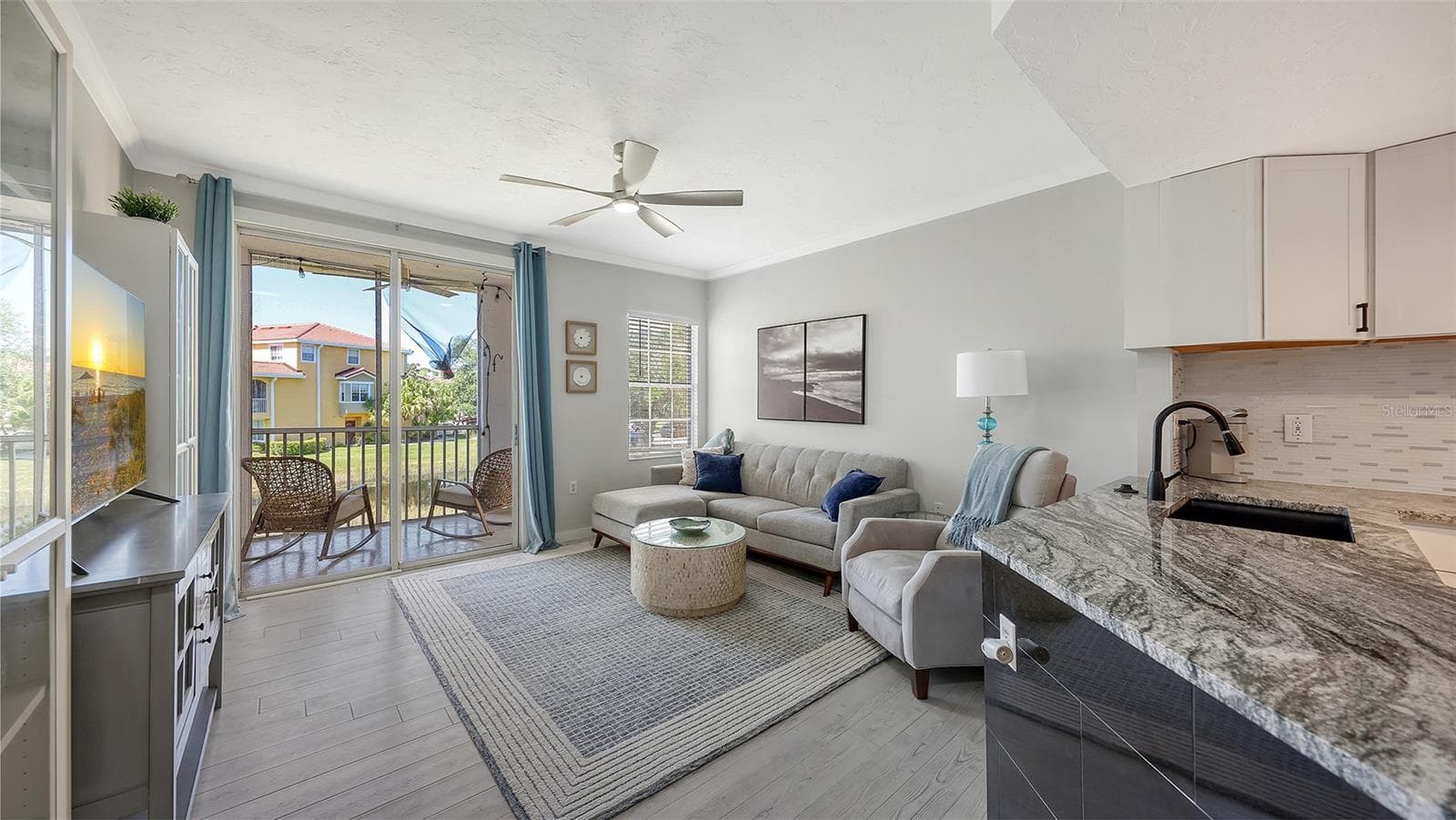 The kitchen flows into the family room. - 5655 BENTGRASS DR #9-116, SARASOTA