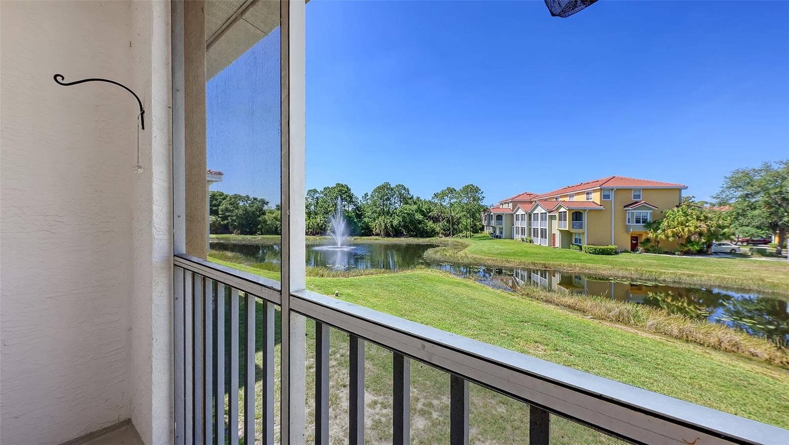Wonderful lanai off the family room with views of the lake.  Lots of nature to experience. - 5655 BENTGRASS DR #9-116, SARASOTA
