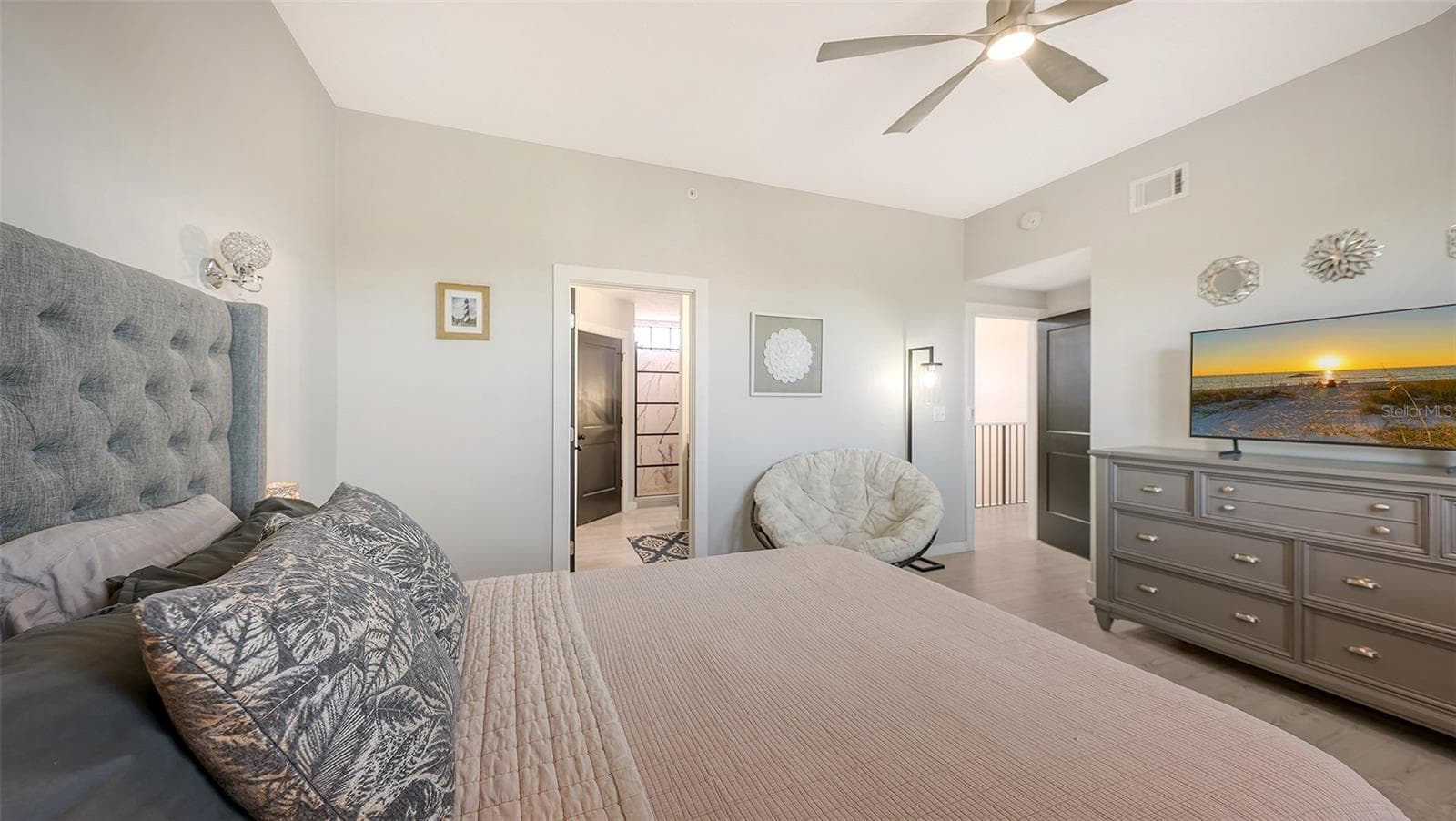 This bedroom has an en suite bath and walk-in shower, along with a walk-in closet. - 5655 BENTGRASS DR #9-116, SARASOTA