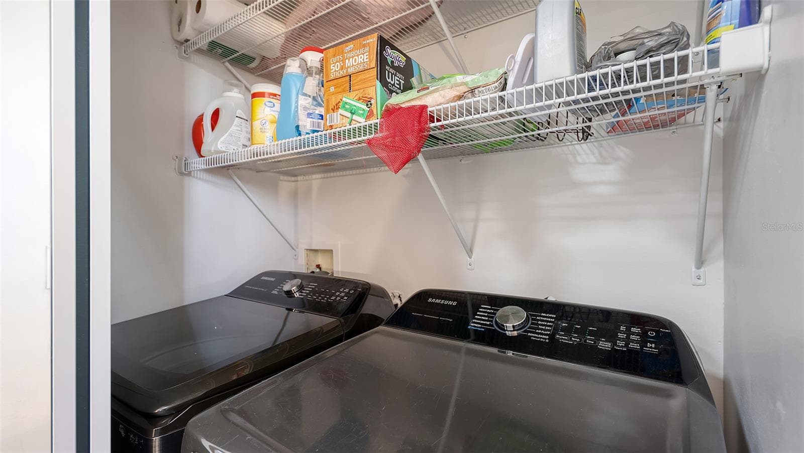The washer and dryer are on the same level as the main bedroom. - 5655 BENTGRASS DR #9-116, SARASOTA