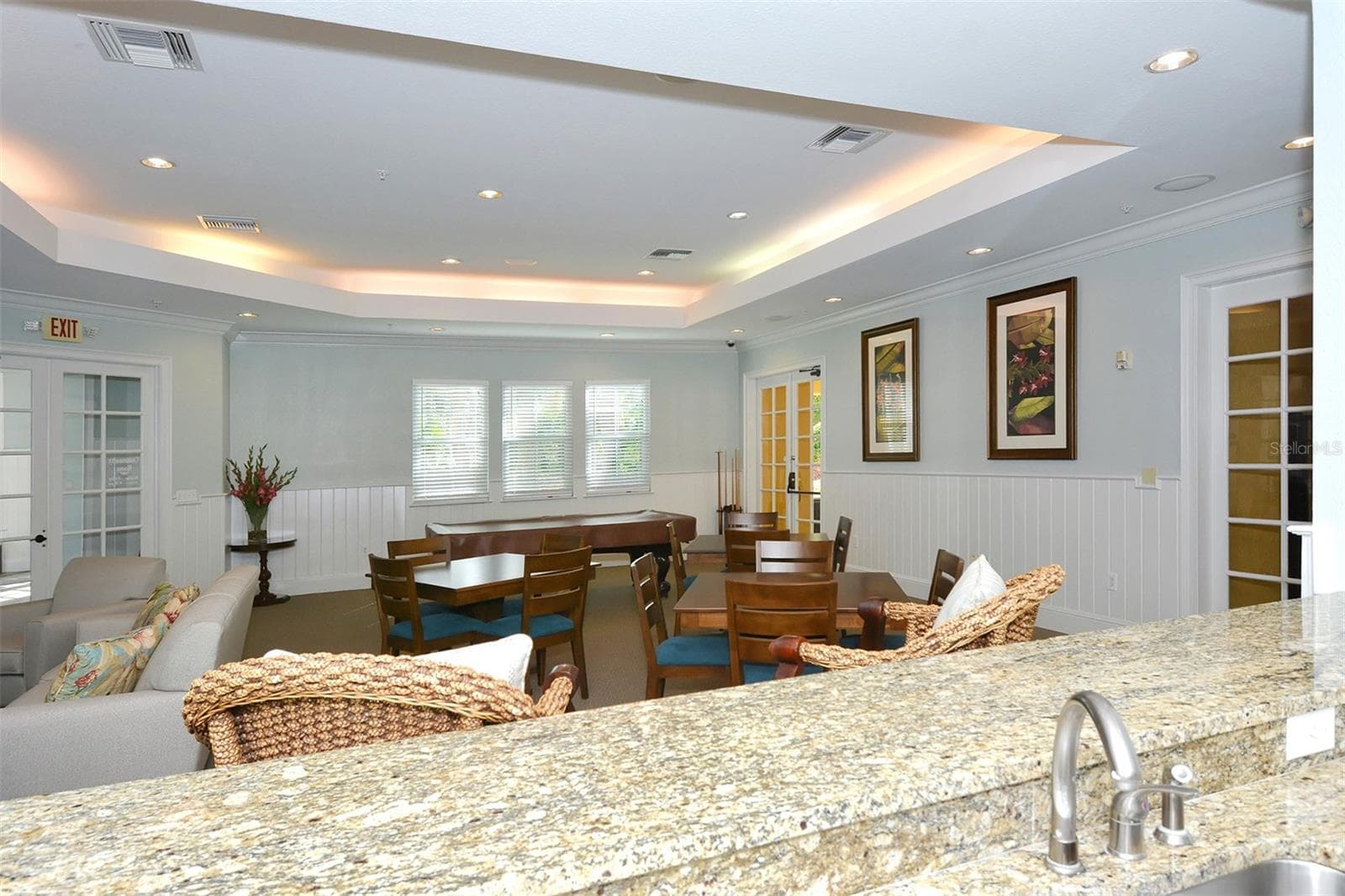 The kitchenette overlooks the gathering area. - 5655 BENTGRASS DR #9-116, SARASOTA