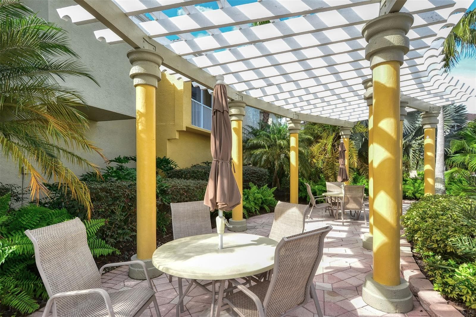 Tables near the community pool. - 5655 BENTGRASS DR #9-116, SARASOTA