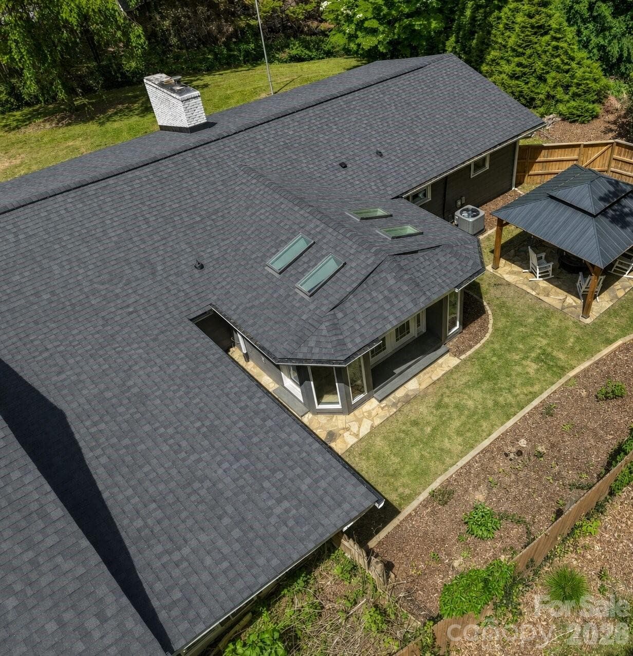 Aerial perspective showcasing the roofline and overall structure of the home. - Arden
