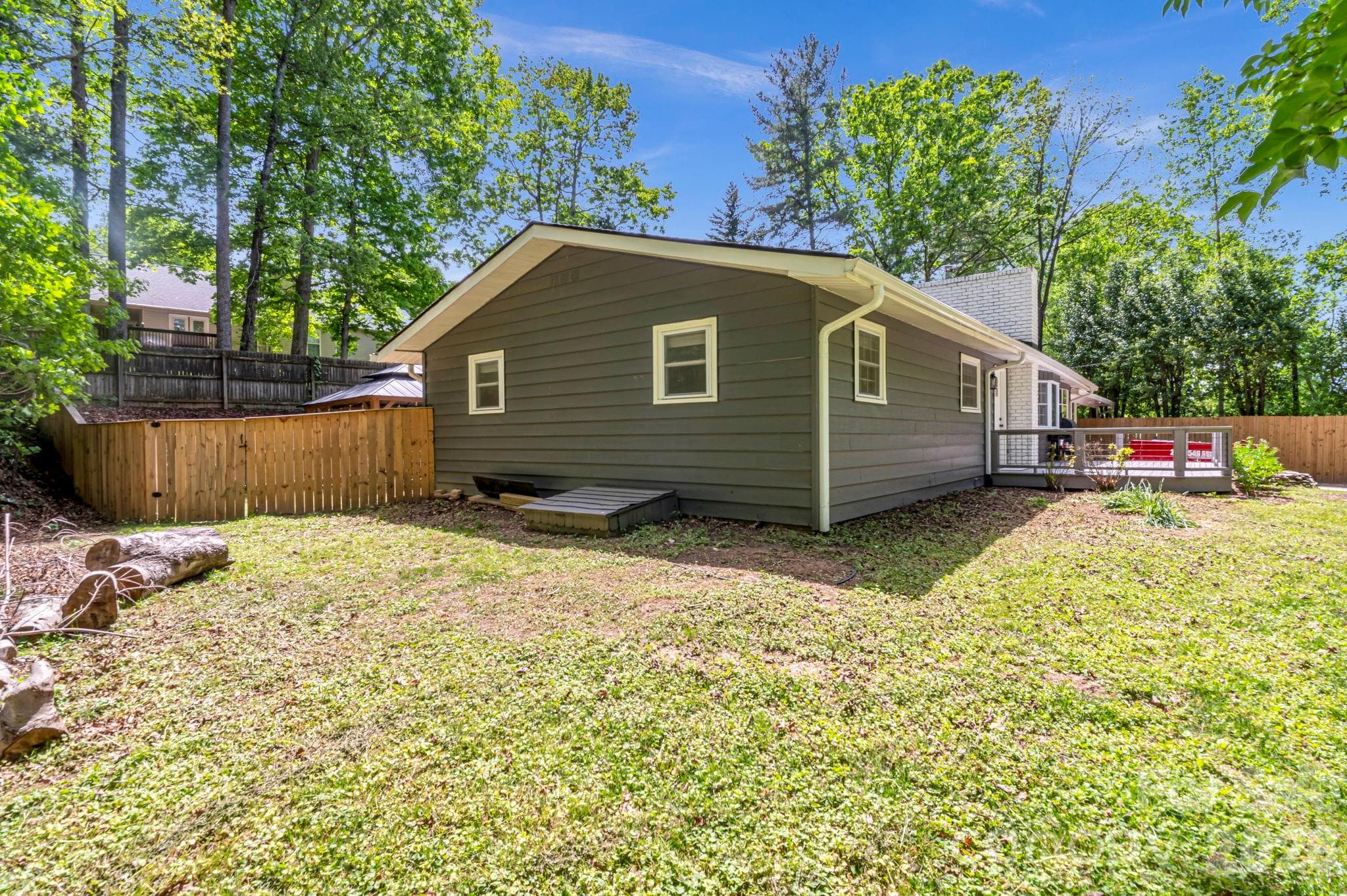 side view with easy crawlspace access and a secure gate leading to the backyard. - Arden