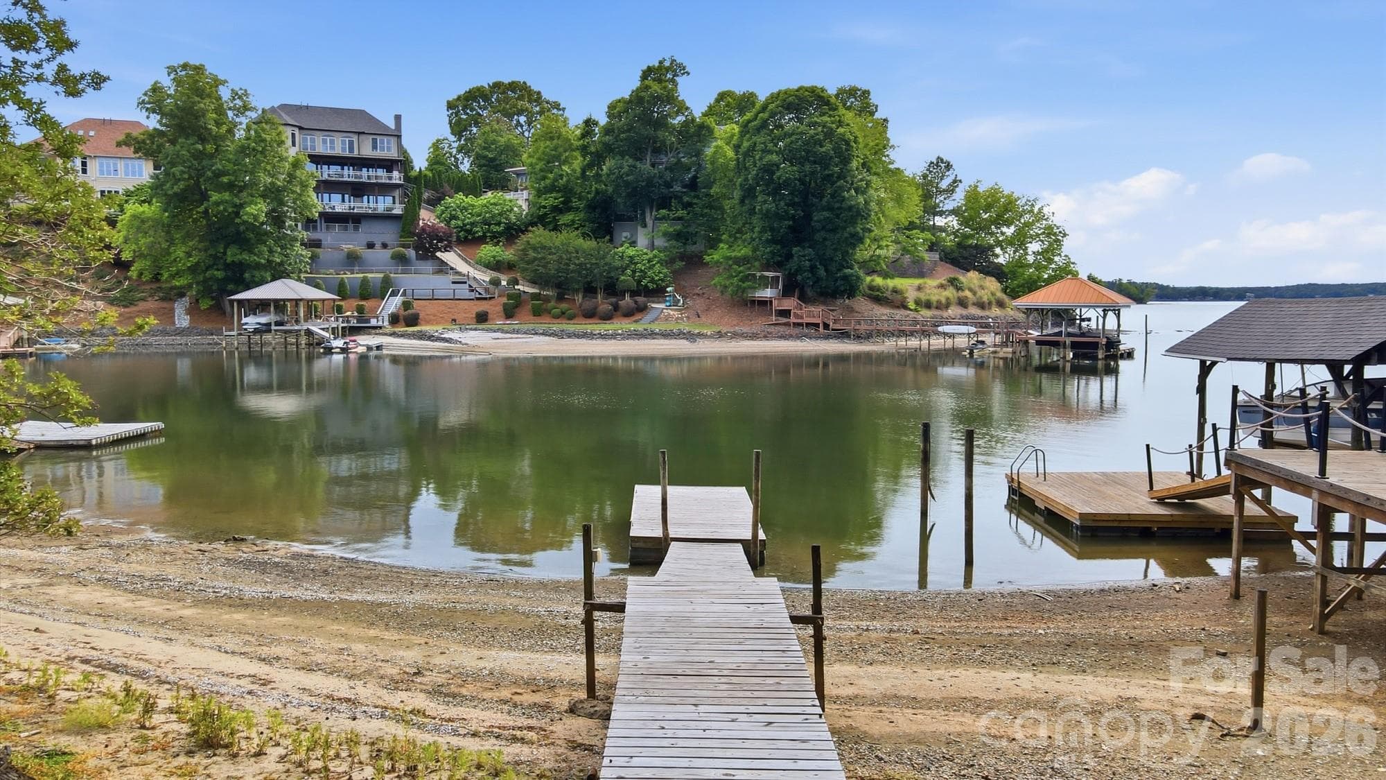 Enjoy a beautiful sandy beach with sweeping views of the main channel — floating dock already in place for easy lake access. - Tega Cay