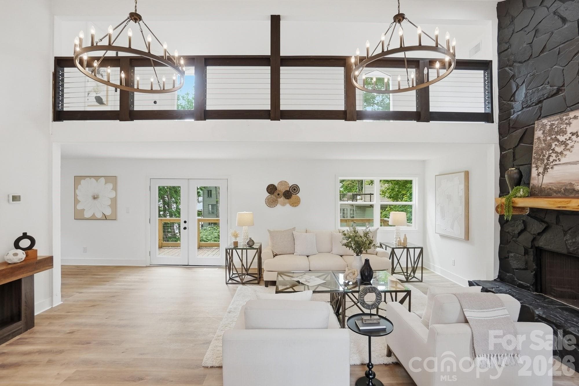 Walls of windows on the back of the home let the light pour in, with a catwalk above just begging to be turned into a reading nook. - Tega Cay