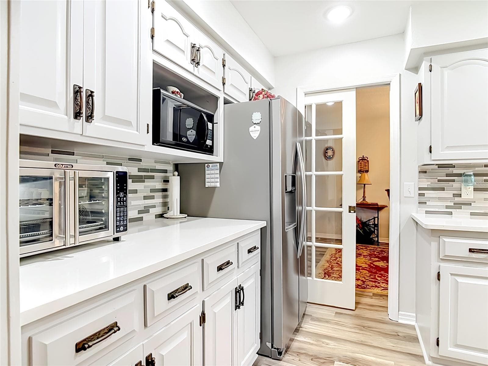 Pocket door between kitchen and dining room - 17819 PALM ST, UMATILLA